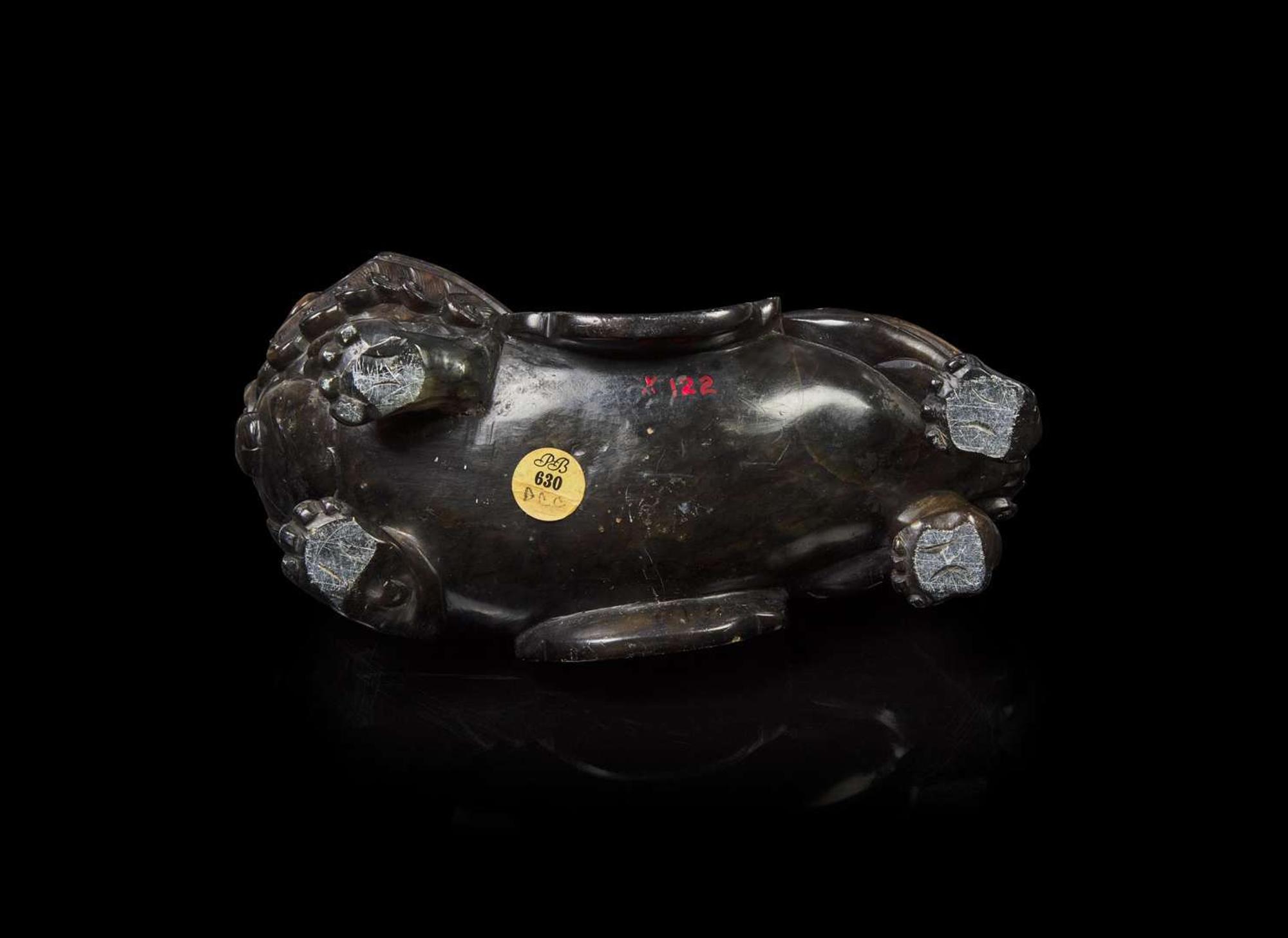 A Chinese carved mottled dark brown soapstone Buddhist lion, 18th century or earlier 壽山石獅子 十八世紀或更早