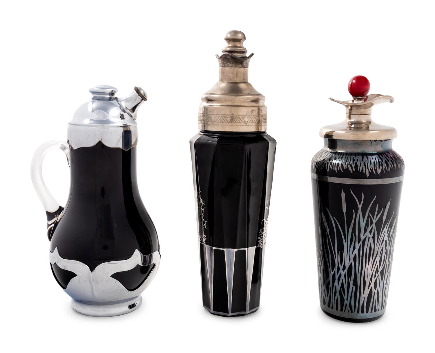 A Group of Three Black Glass Cocktail Shakers