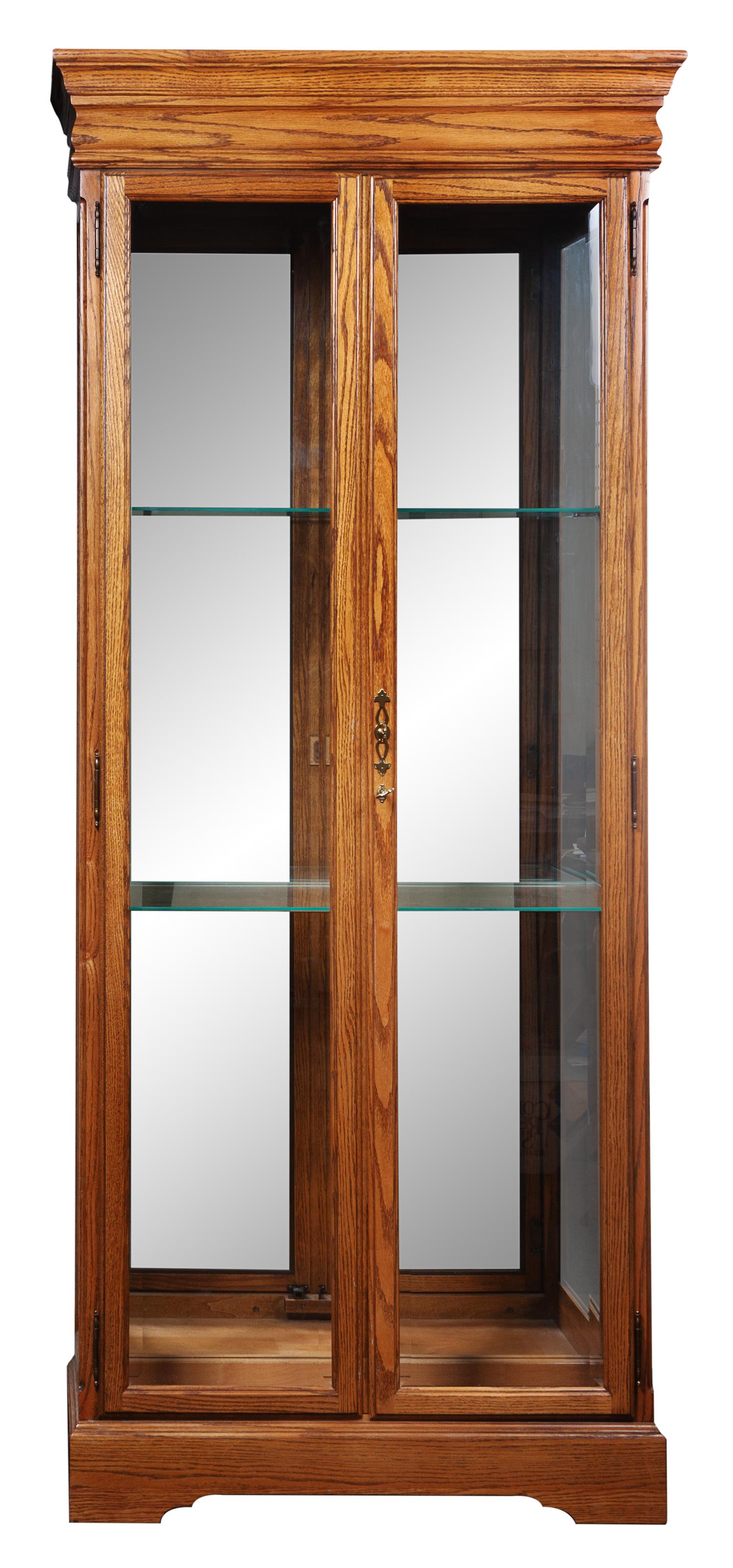 Three Wood and Glass Cases Height 79 inches.