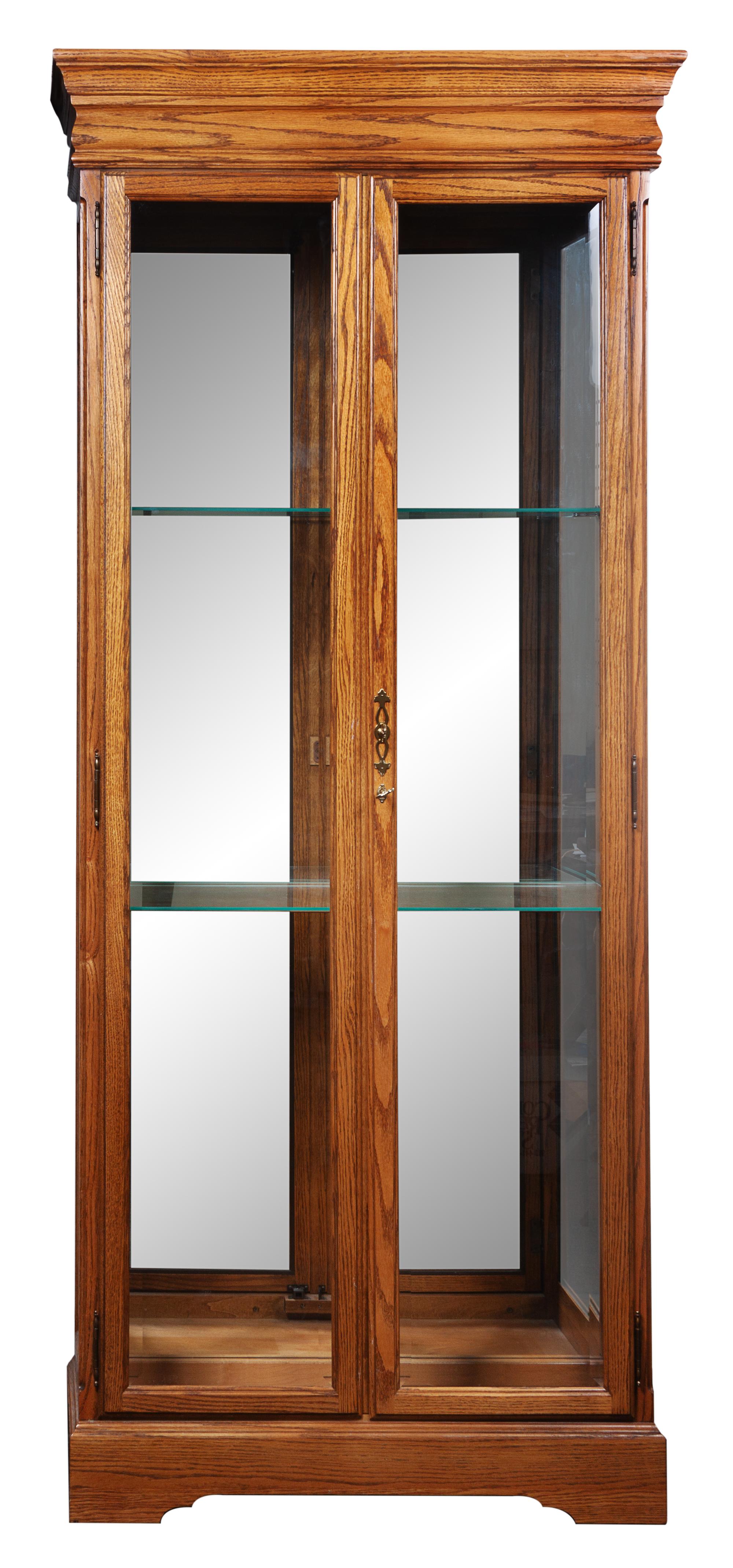 Three Wood and Glass Cases Height 79 inches.
