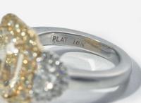A Platinum, 18K Yellow Gold, Diamond, and 5.12 Carat Yellow Diamond Ring