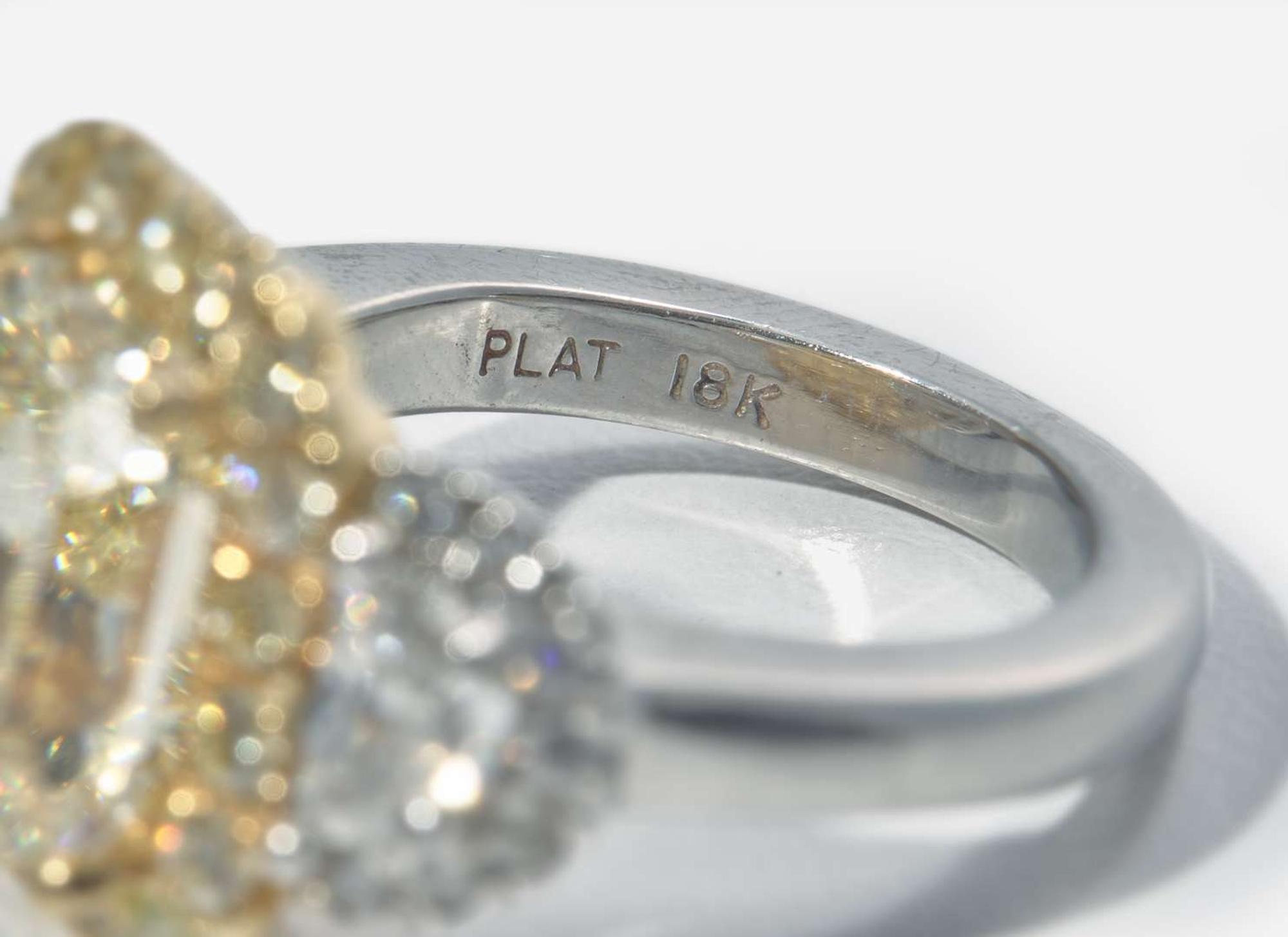 A Platinum, 18K Yellow Gold, Diamond, and 5.12 Carat Yellow Diamond Ring