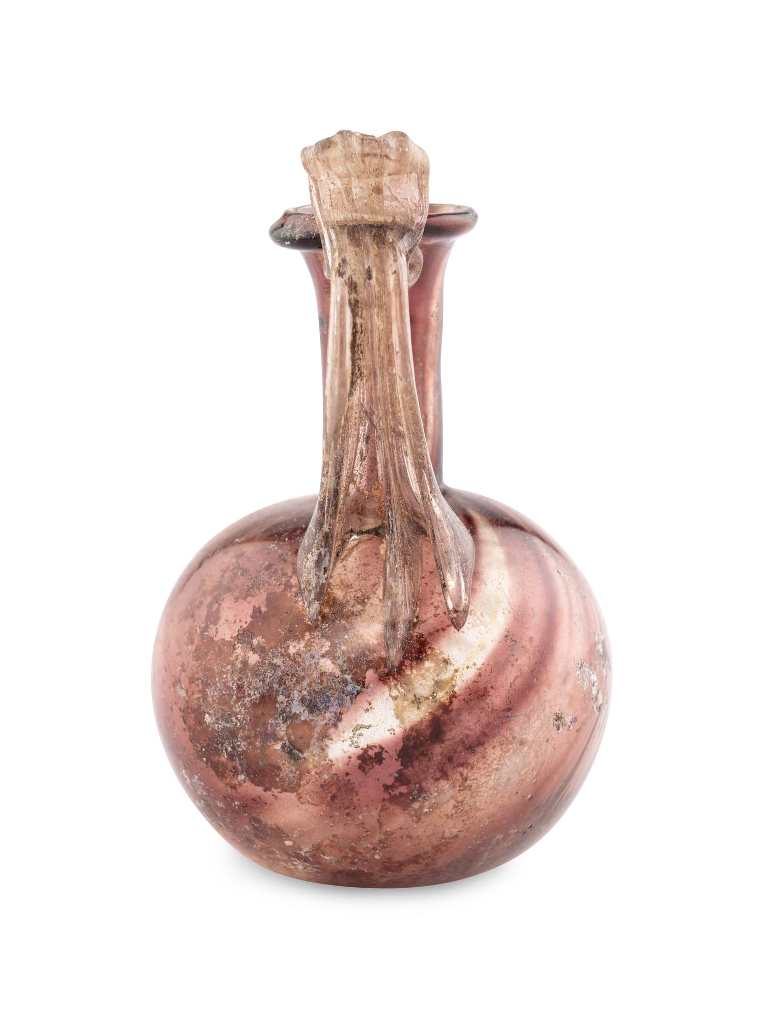 A Roman Glass Jug with Fluted Handle and Thumb Rest