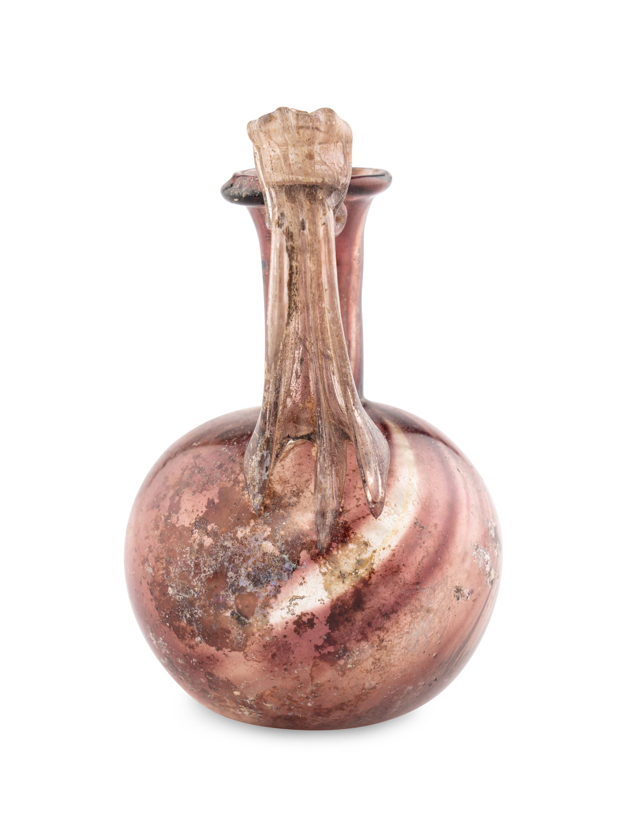 A Roman Glass Jug with Fluted Handle and Thumb Rest
