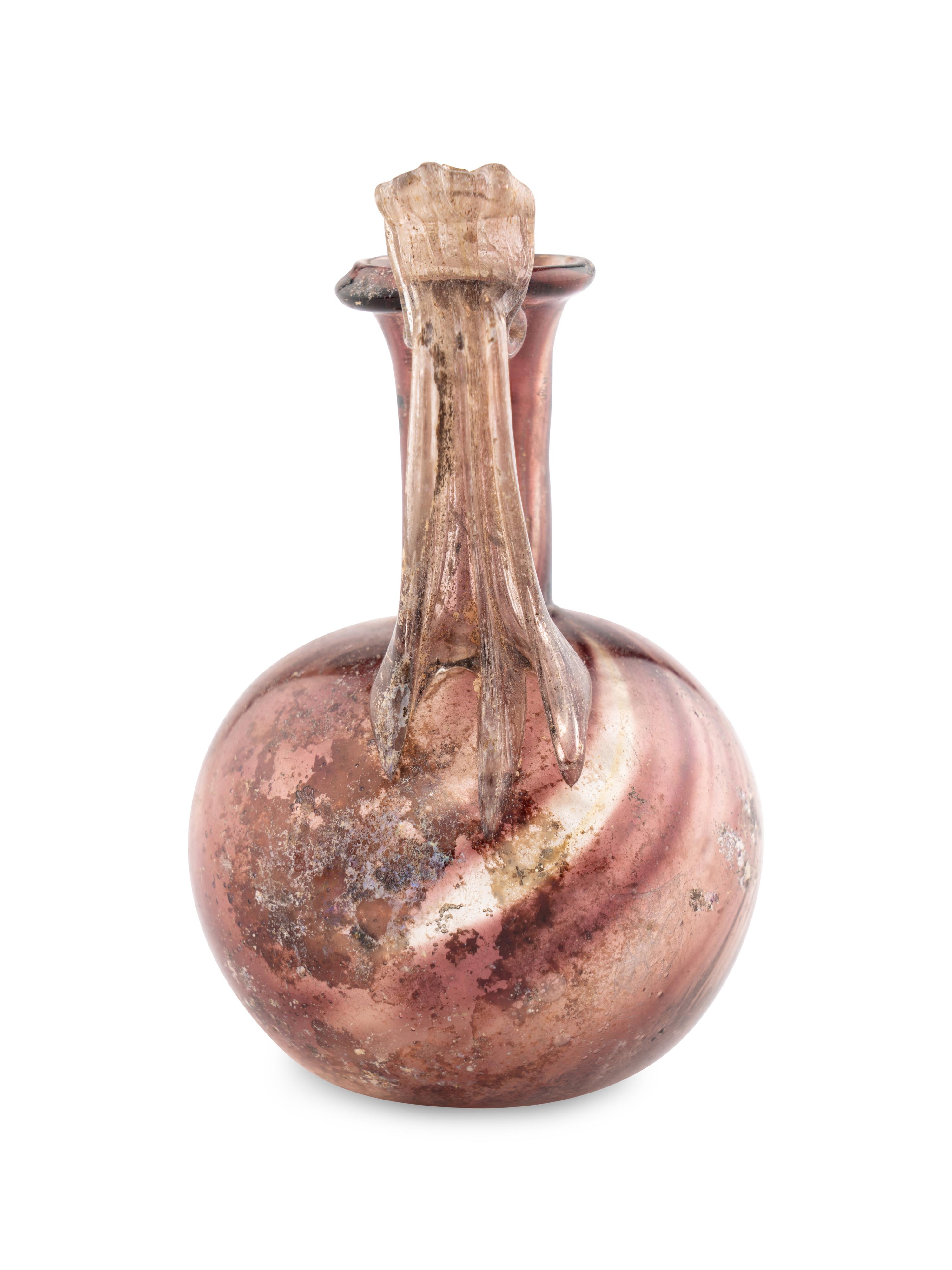 A Roman Glass Jug with Fluted Handle and Thumb Rest