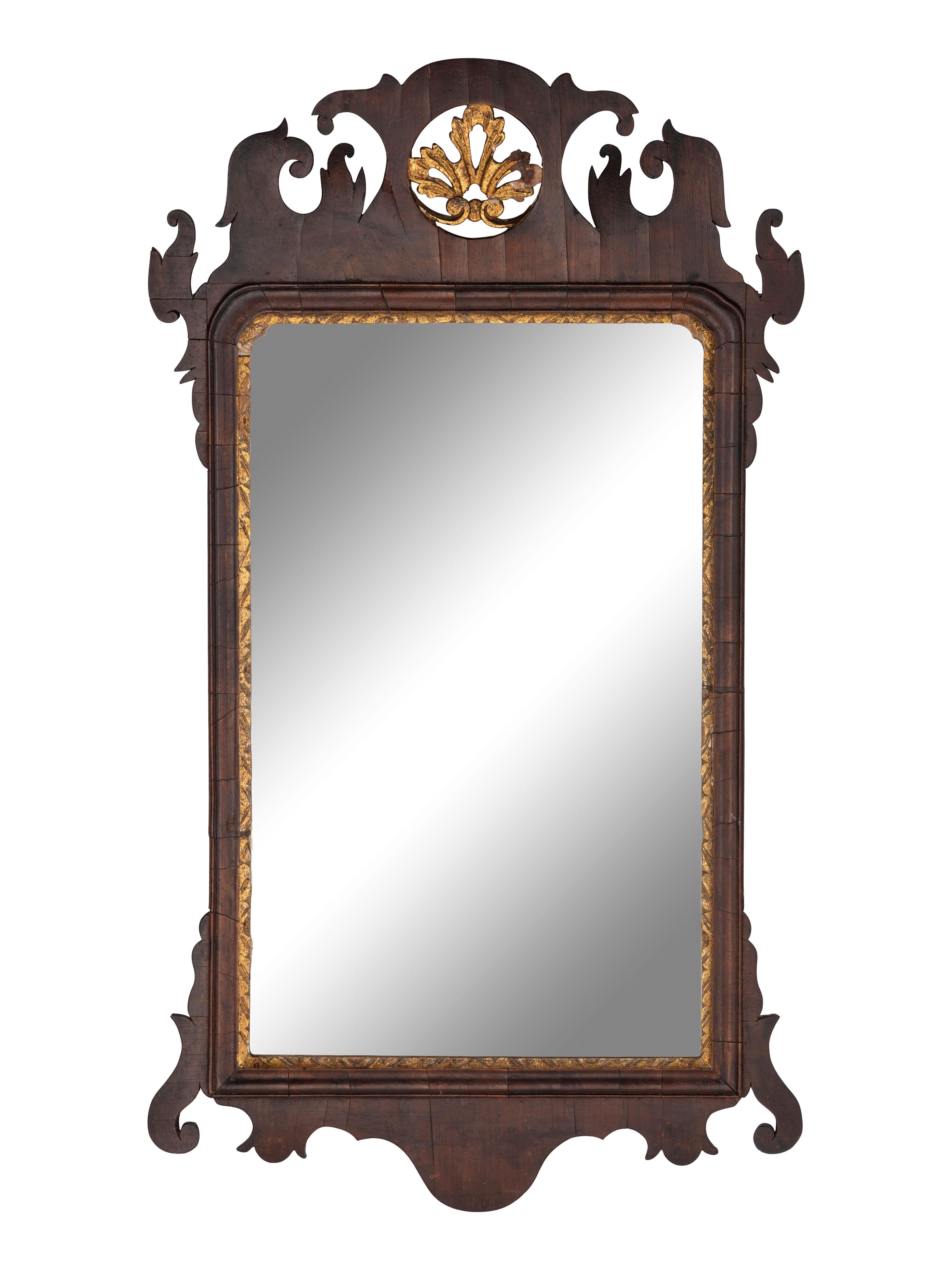 A Chippendale Carved and Parcel-Gilt Figured Mahogany Looking Glass