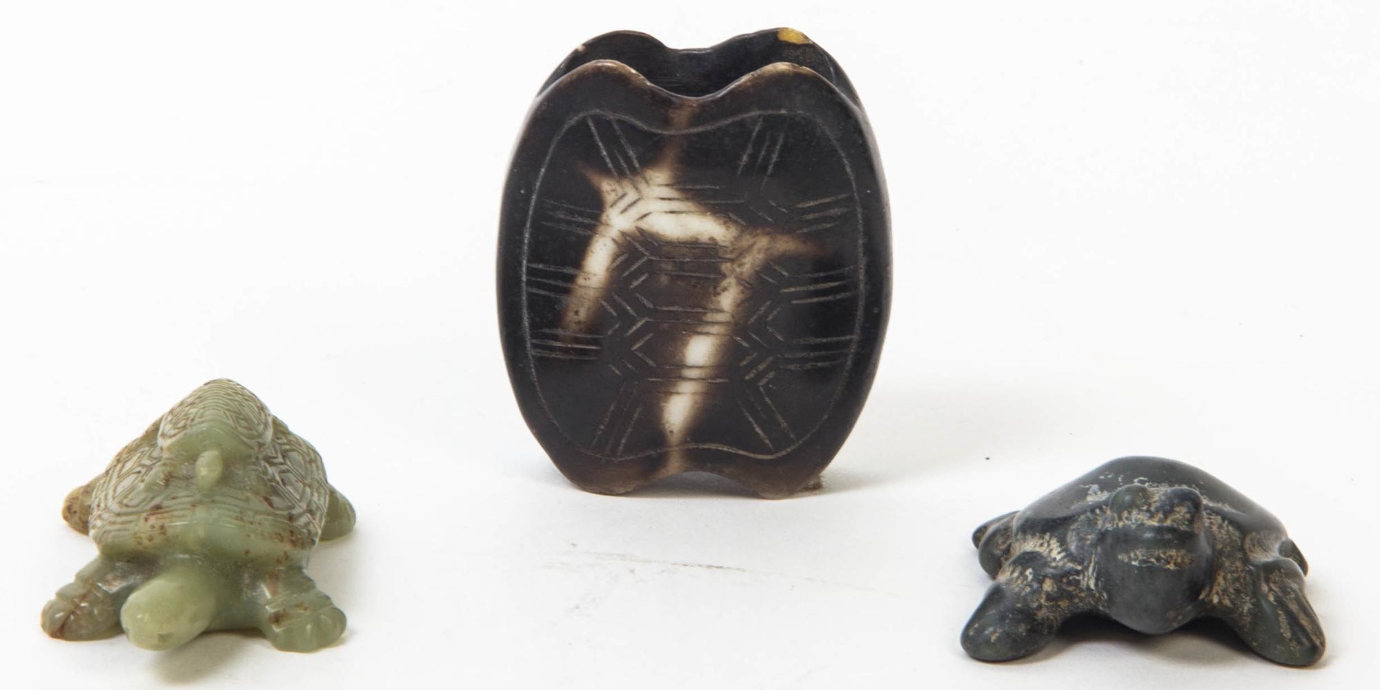 A Group of Three Carved Hardstone Toggles Length of longest 2 3/8 inches.