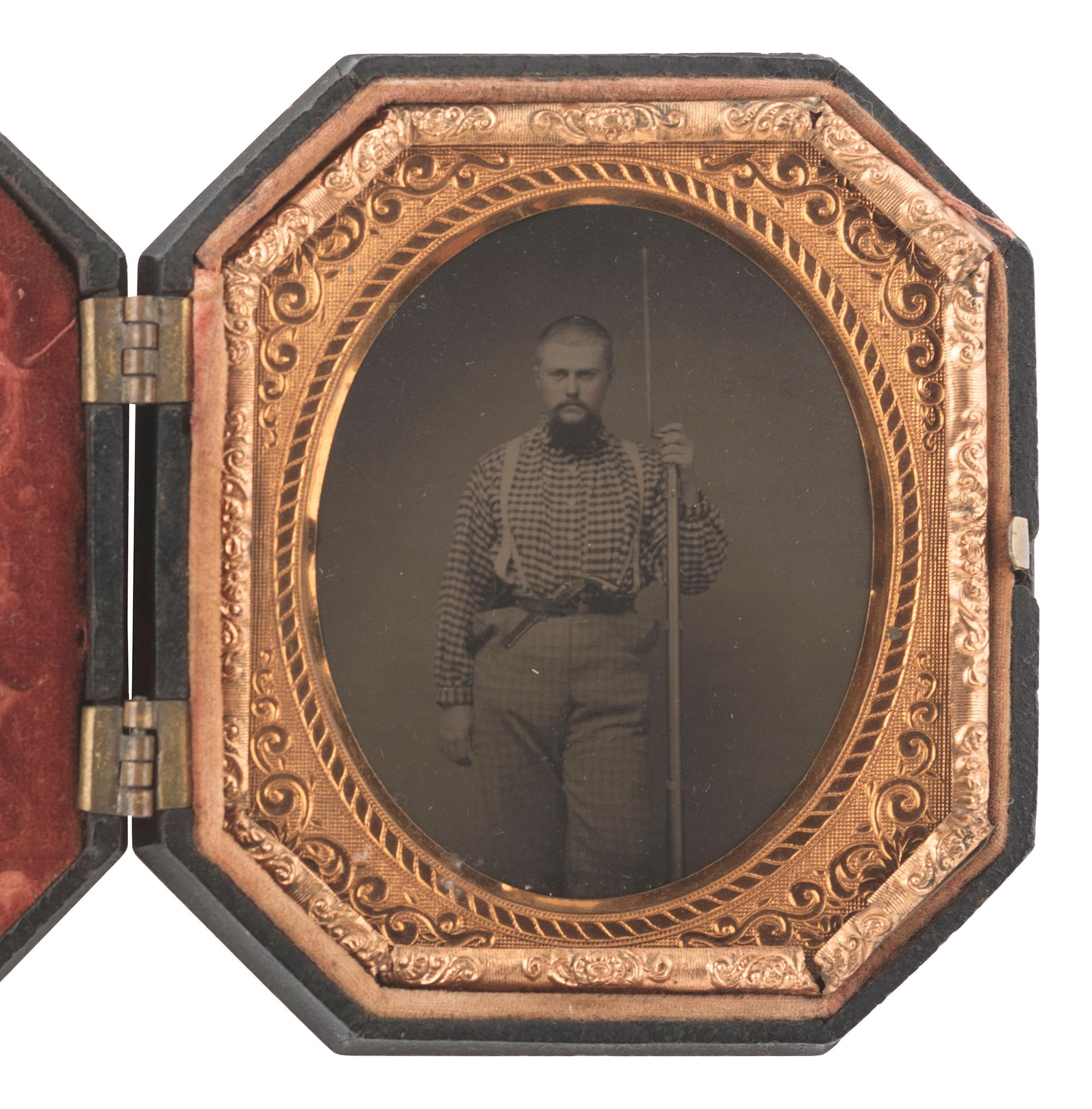 [CIVIL WAR]. Sixth plate tintype of a doubly armed soldier with shaved head, possibly Confederate.