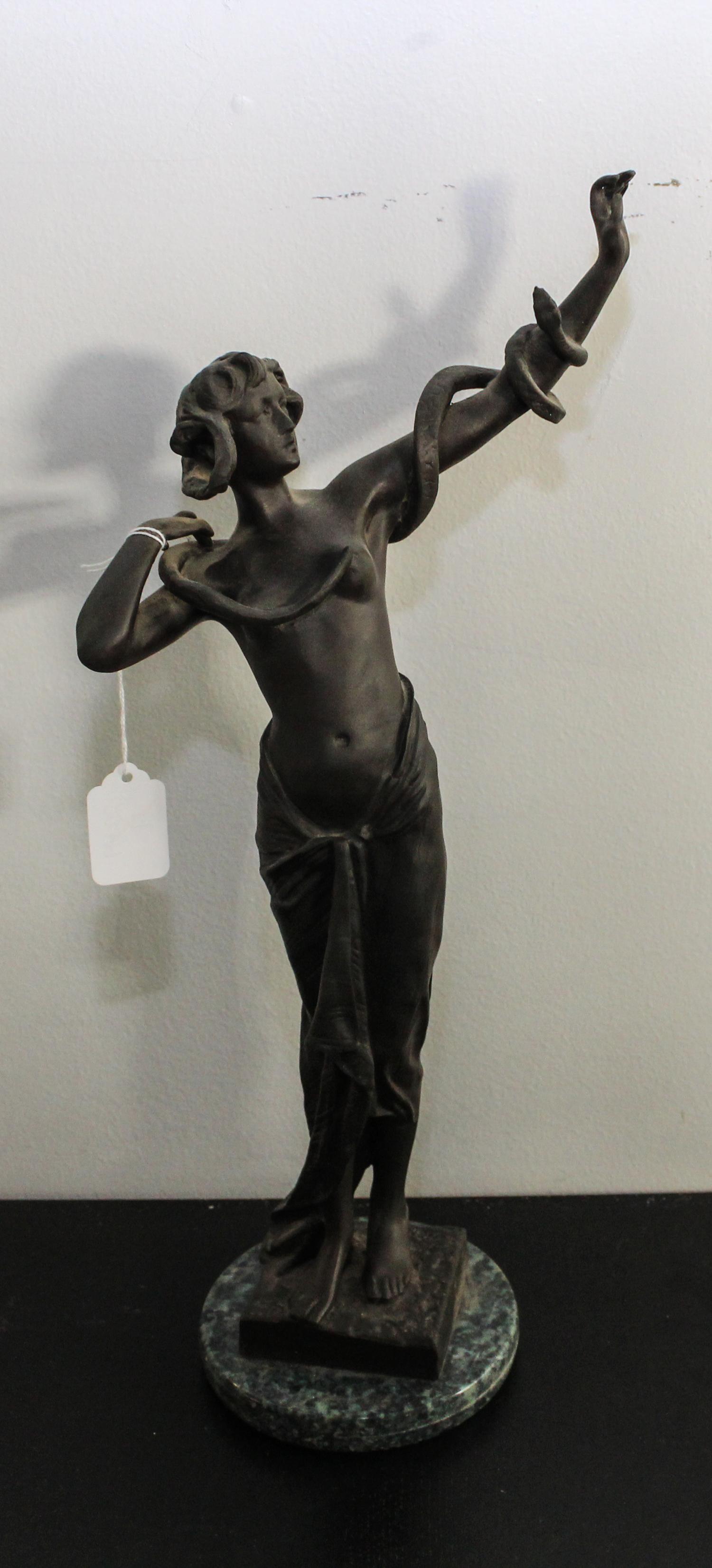 A Continental Bronze Snake Charmer Height overall 18 inches.