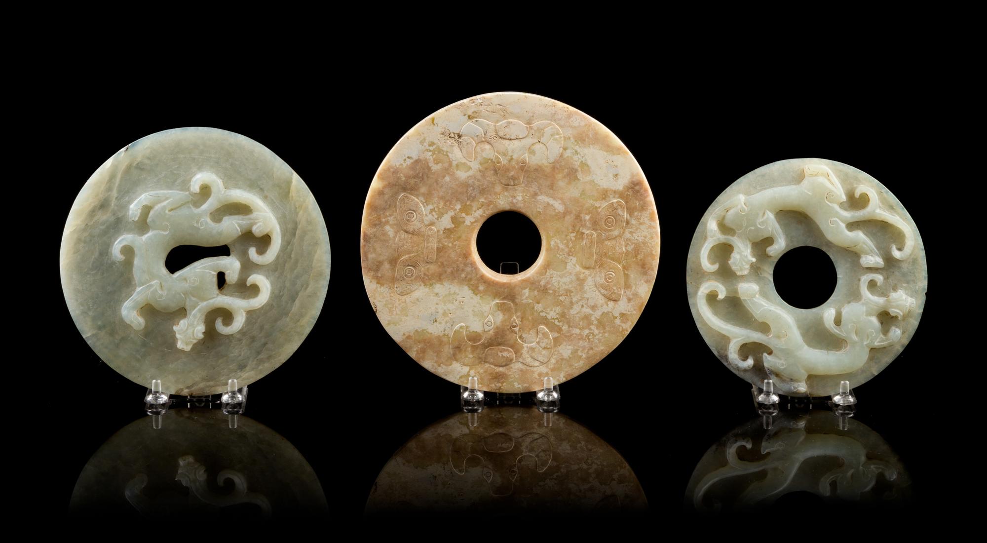 A Group of Seven Carved Jade Bi Discs Diameter of largest 9 inches.