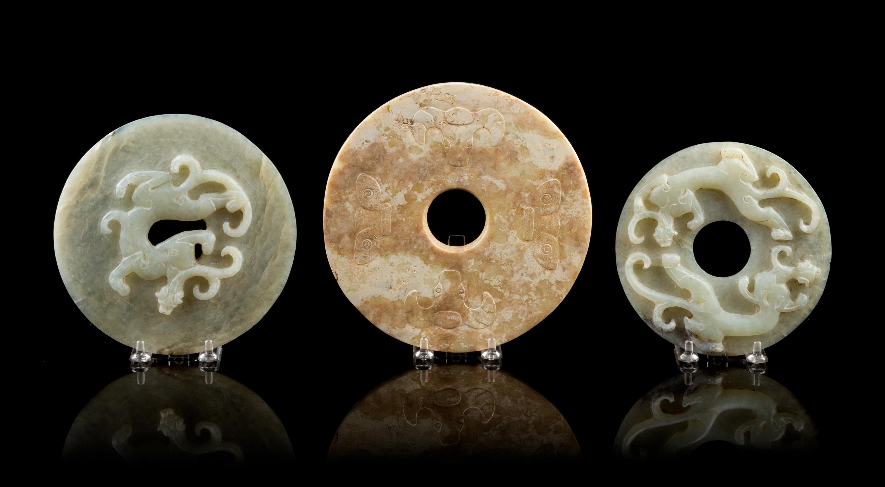 A Group of Seven Carved Jade Bi Discs Diameter of largest 9 inches.