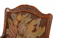 A Pair of Régence Style Carved Walnut Fauteuils