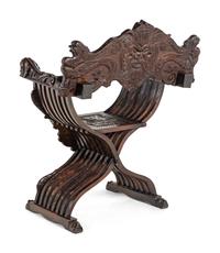 An Italian Renaissance Revival Carved Walnut Savonarola Armchair