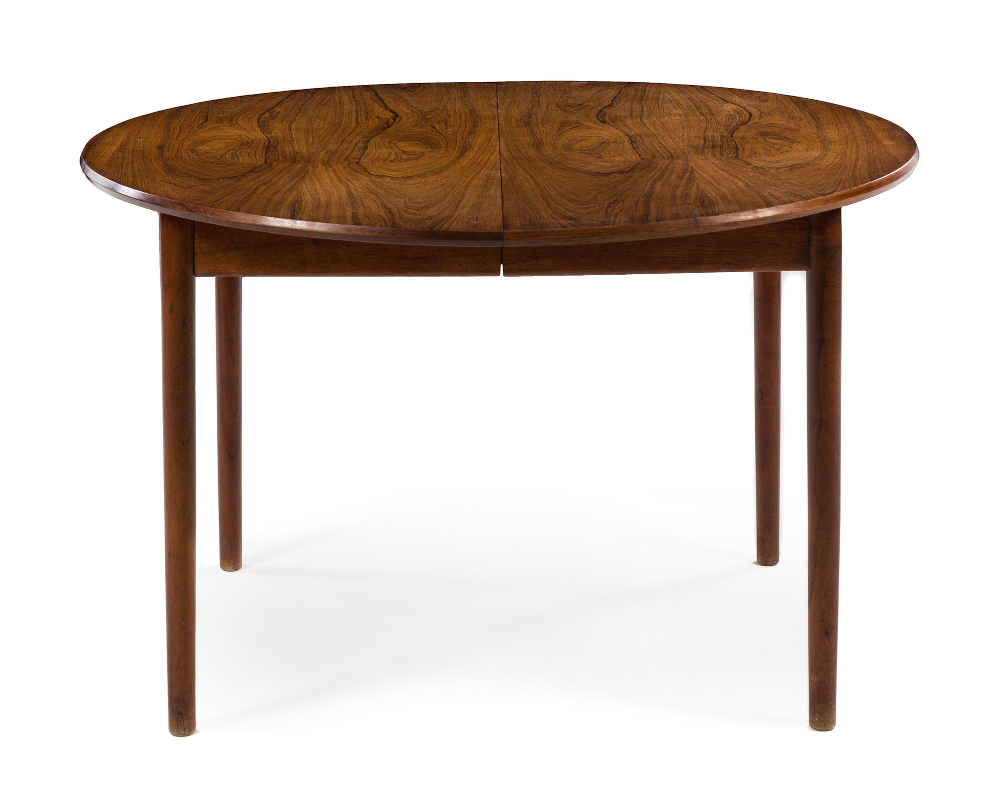 A Circular Danish Teak Dining Table, with three leaves — 1960s