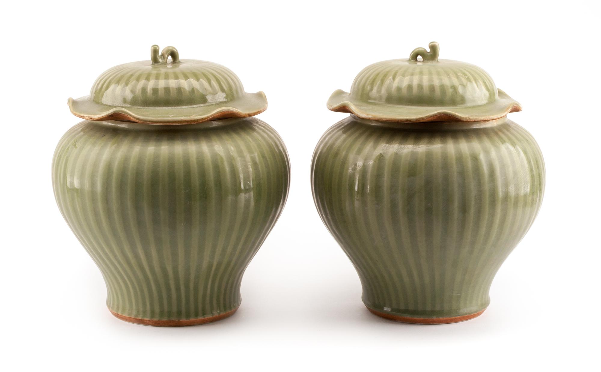 A Pair of Chinese Celadon Glazed Covered Vases Height 14 inches.