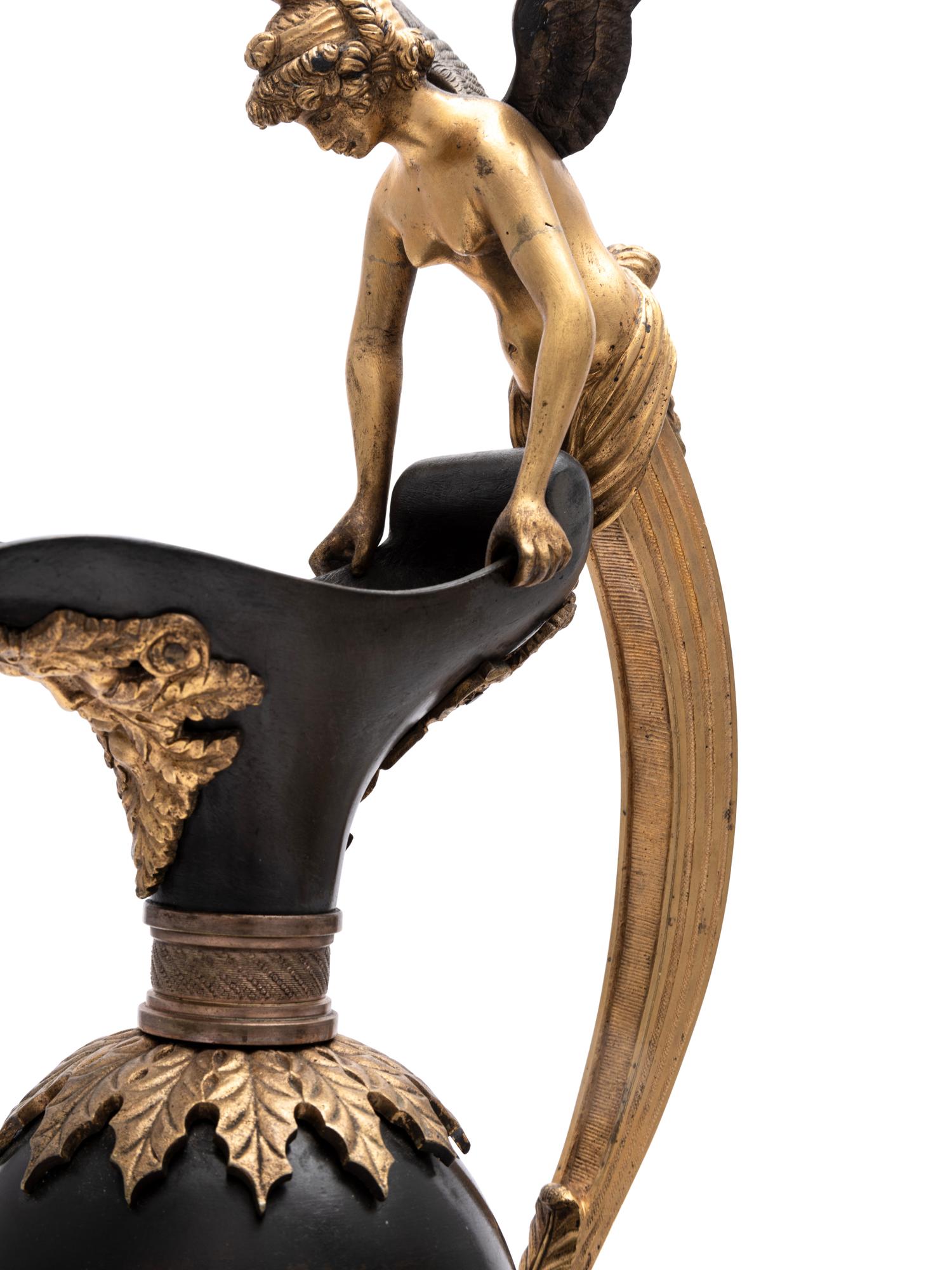A Pair of Continental Gilt and Patinated Bronze Ewers