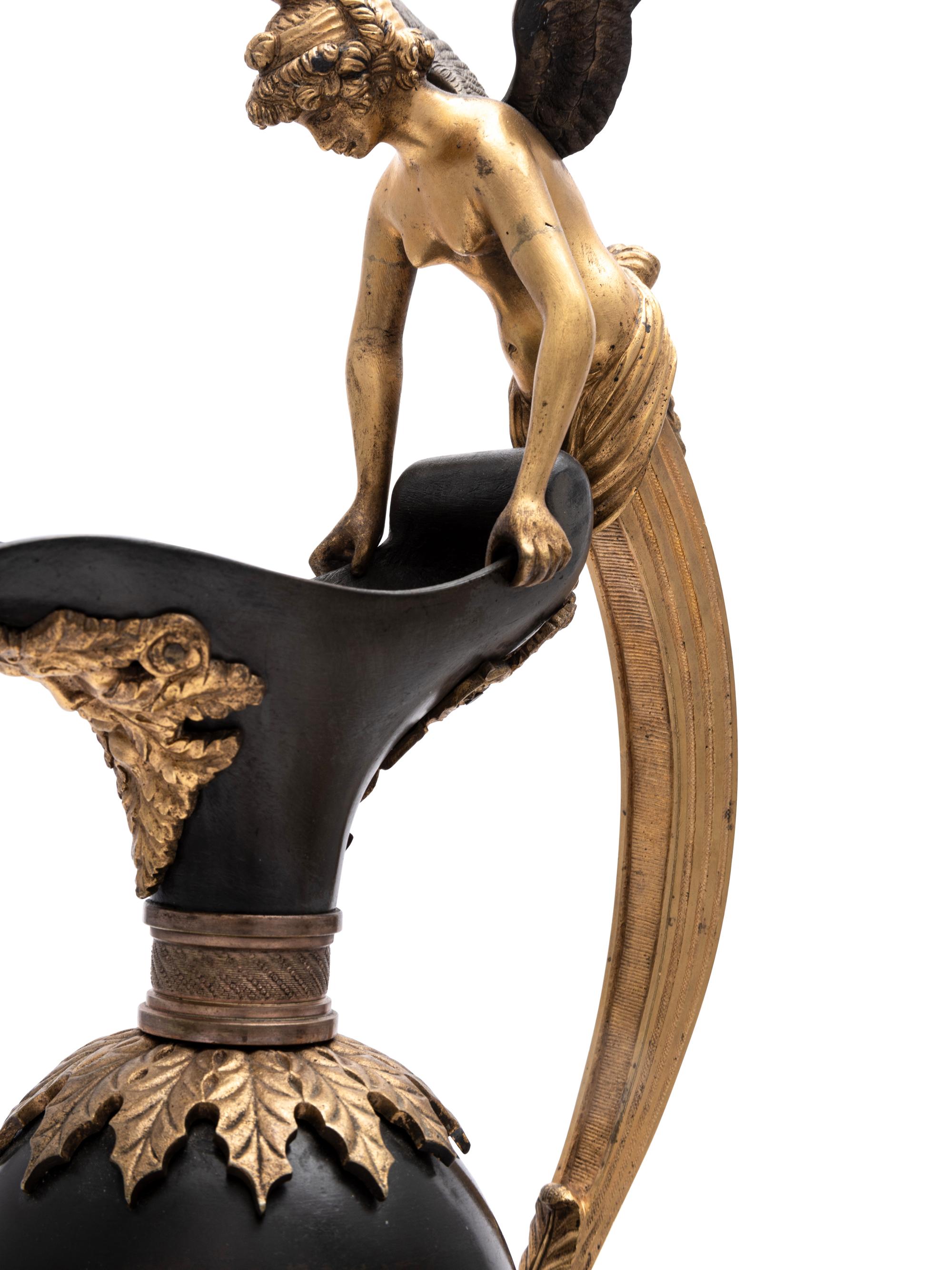 A Pair of Continental Gilt and Patinated Bronze Ewers