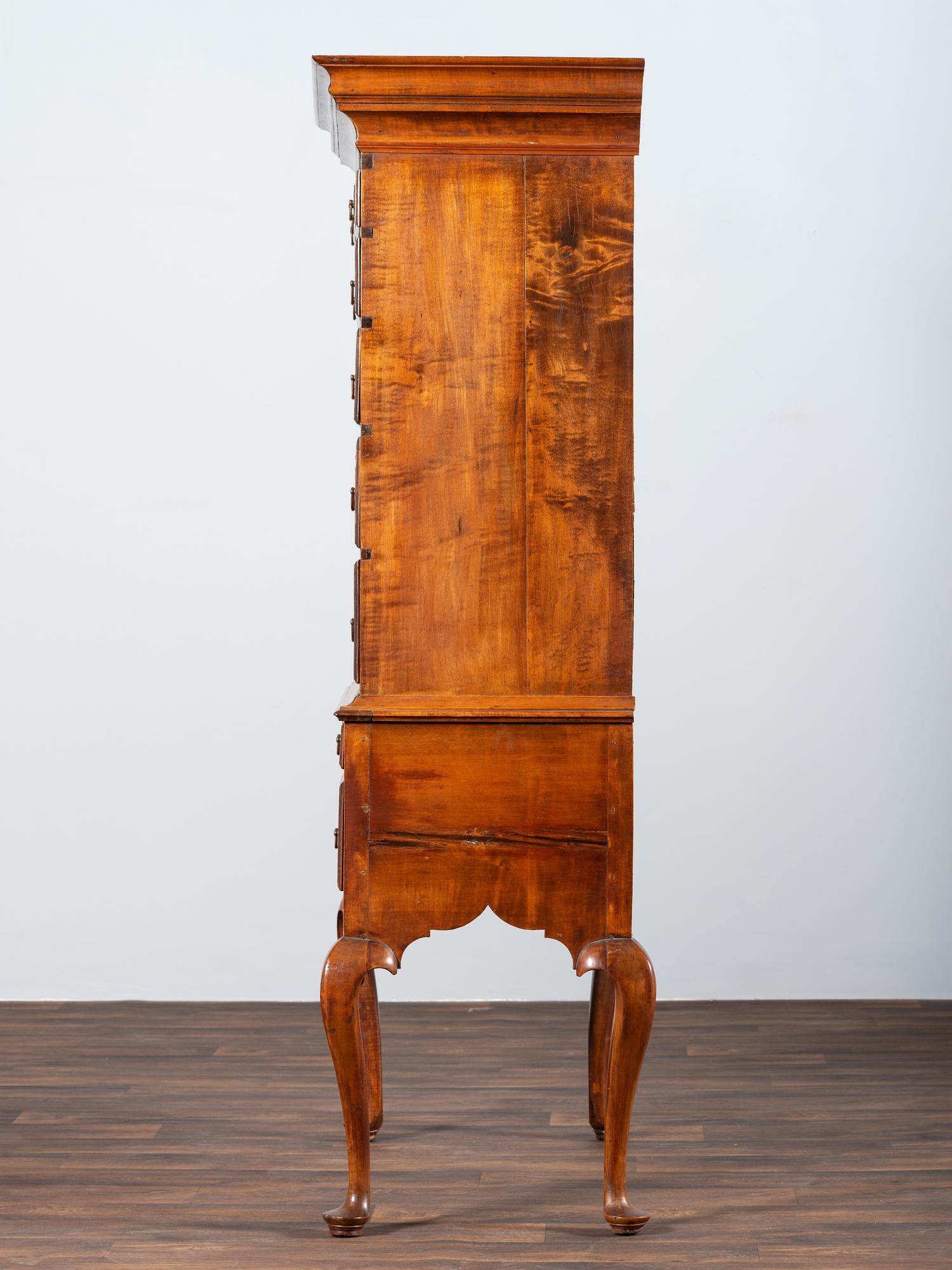 A Queen Anne Shell-Carved and Figured Maple Flat-Top High Chest of Drawers