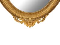 A Louis XV Style Giltwood Framed Oval Mirror — 19TH CENTURY