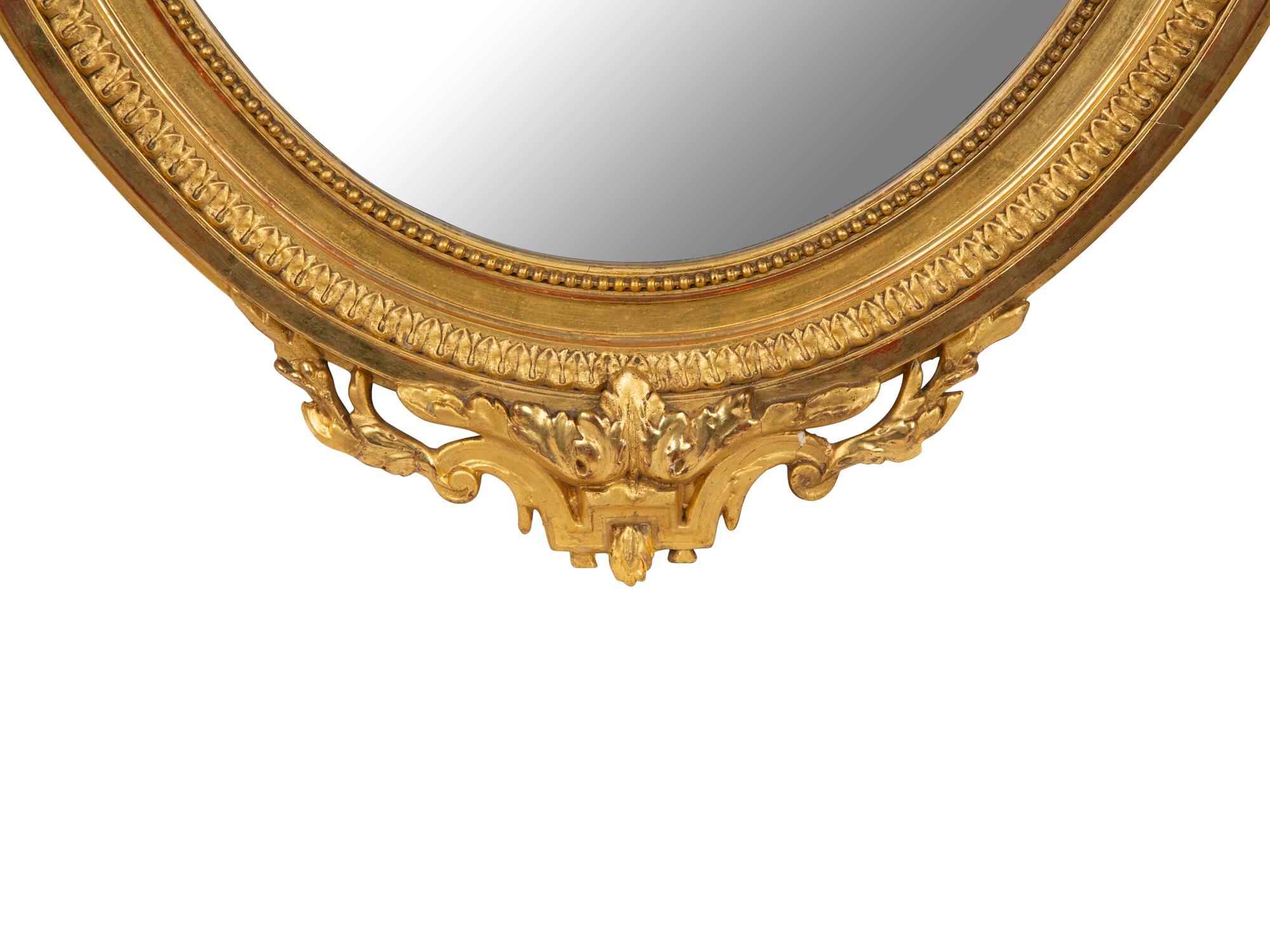 A Louis XV Style Giltwood Framed Oval Mirror — 19TH CENTURY