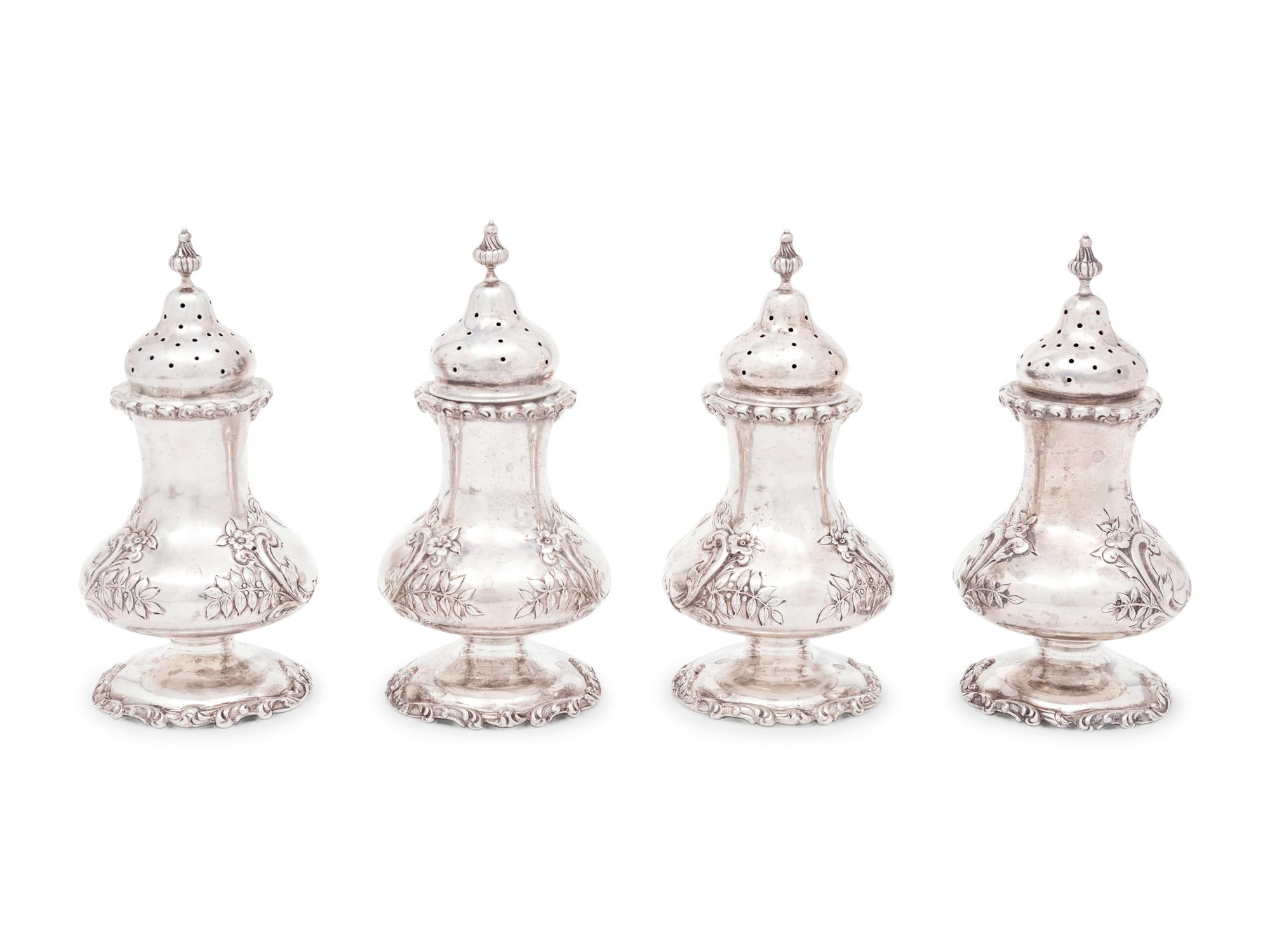 A Group of Sixteen Silver Casters