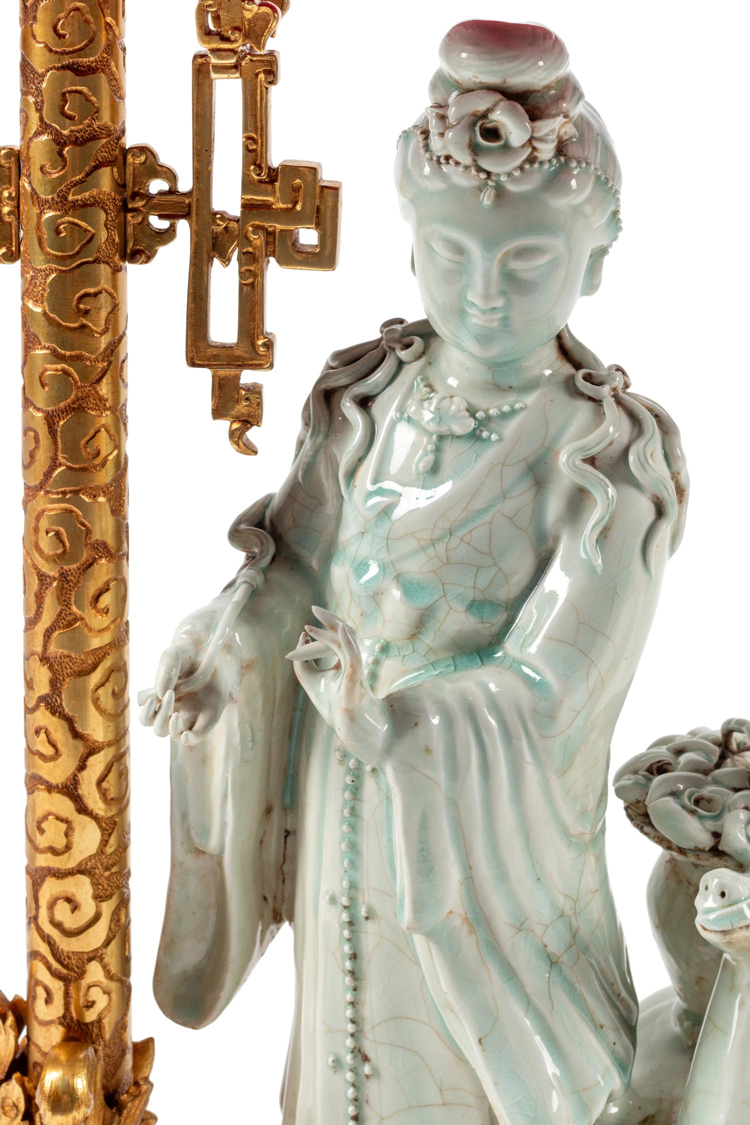 A Continental Gilt Bronze and Celadon Porcelain Figural Chinoiserie Clock