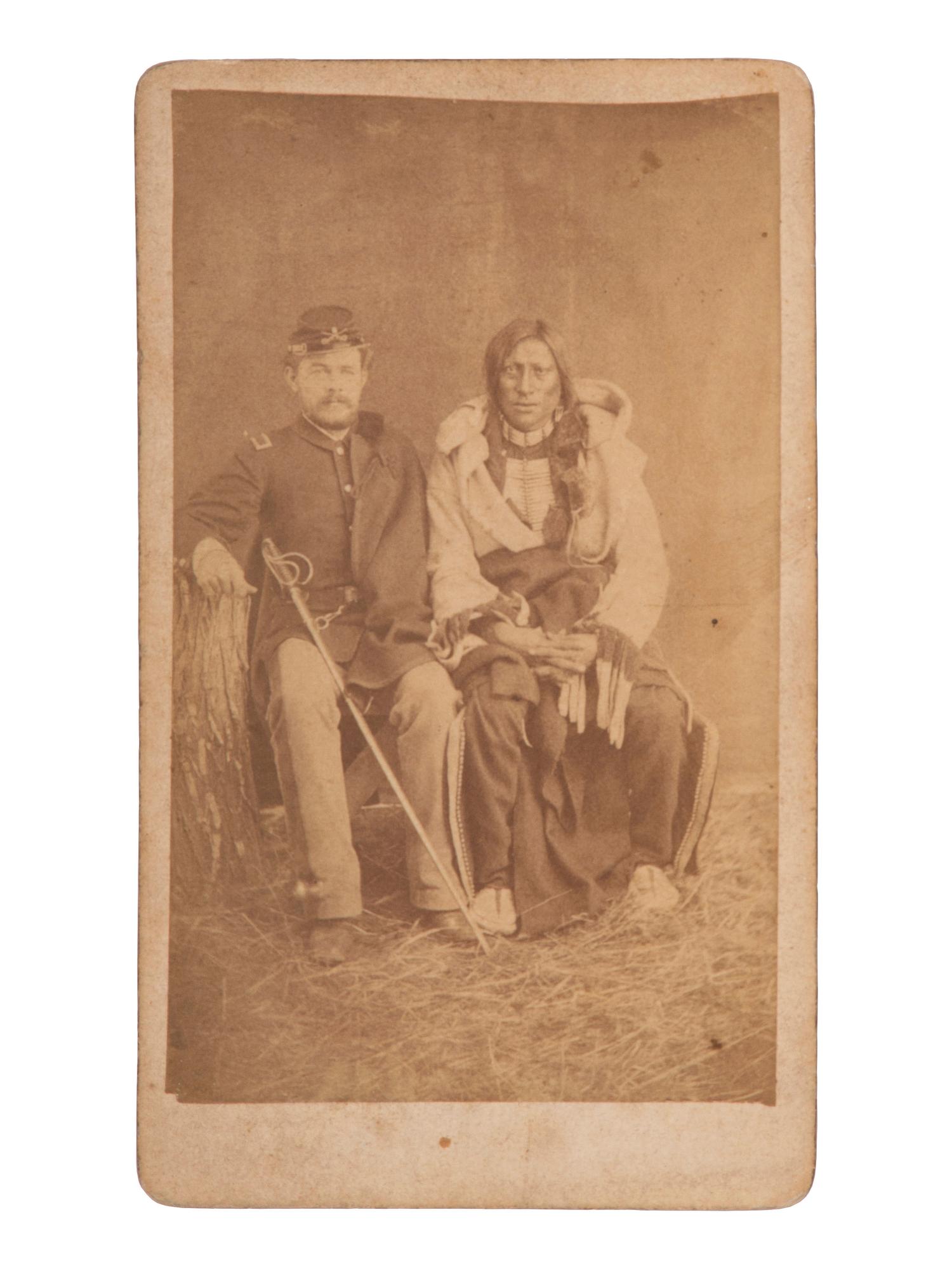 [NATIVE AMERICANS]. CROSS, William R. (1839-1907), photographer. CDV of Brulé Lakota Sioux Chief Hollow Horn Bear with an unidentified 5th US Cavalry second lieutenant. Niobrara, NE: [ca 1880].