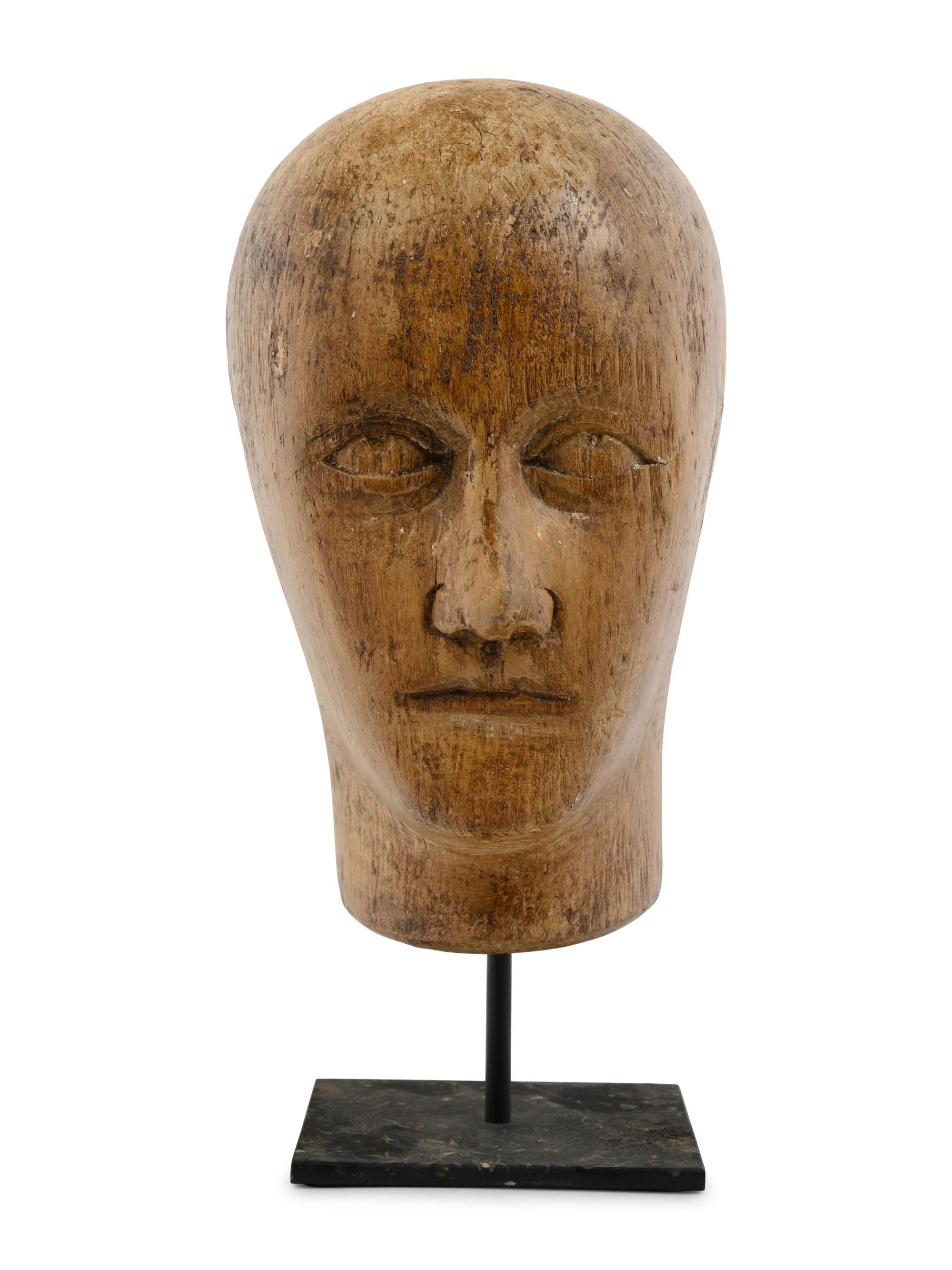 A Carved Wood Mannequin Head