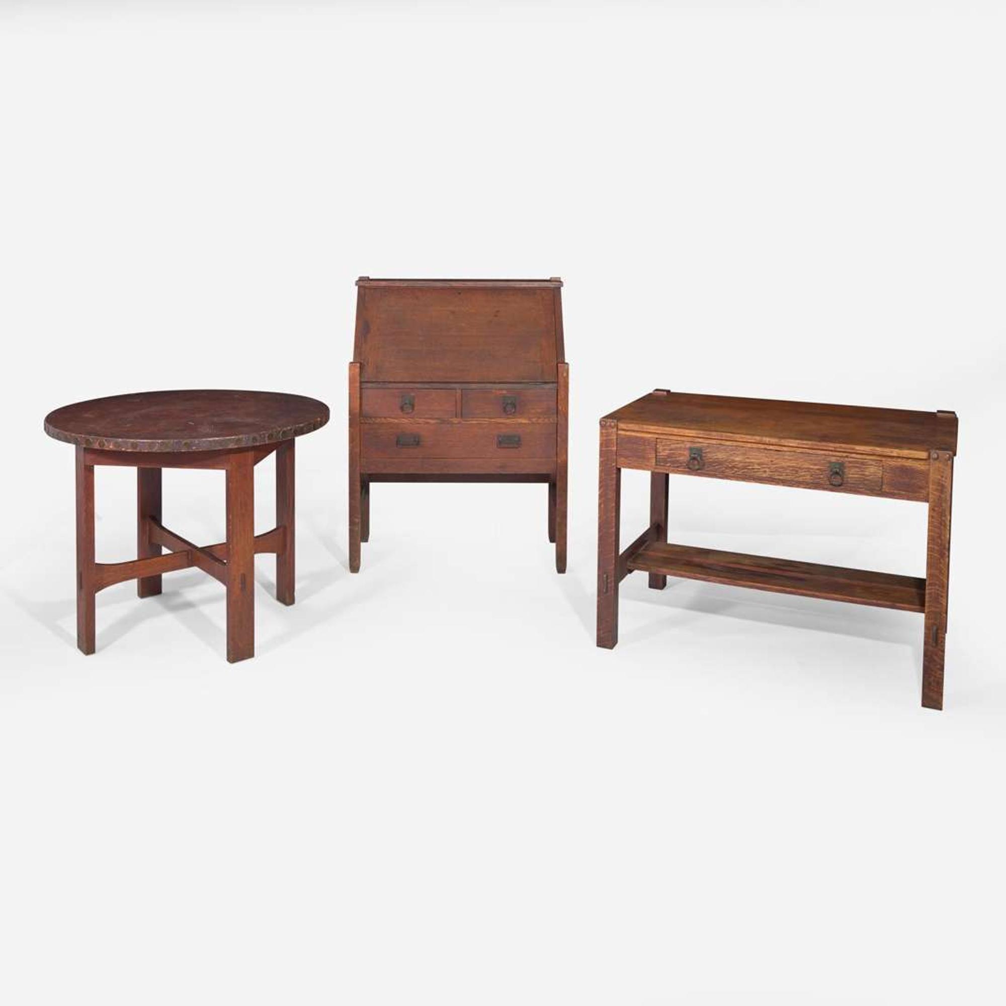 Stickley Brothers (American, active 1891-1954) A Fall-Front Desk, Library Table, and Lamp Table Model No. 180, USA, circa 1905