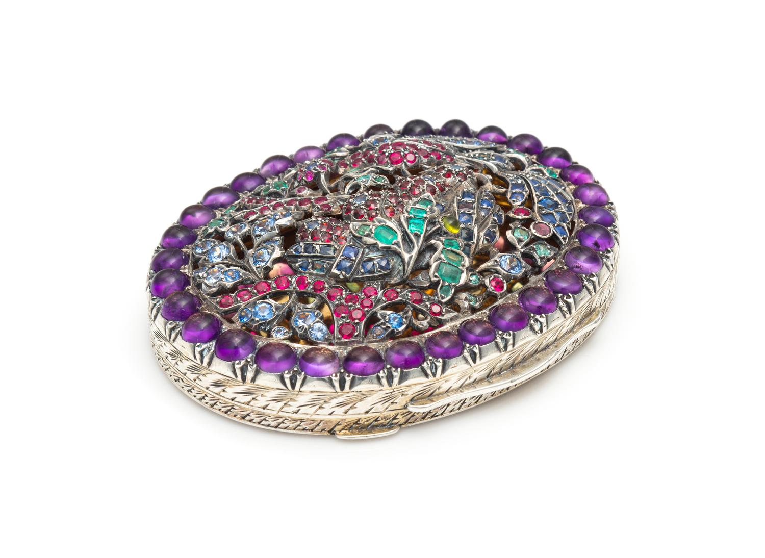 A Continental Silver and Gemstone Compact, 20th Century, of oval form, the pierced lid set with both natural and faux amethysts, sapphi