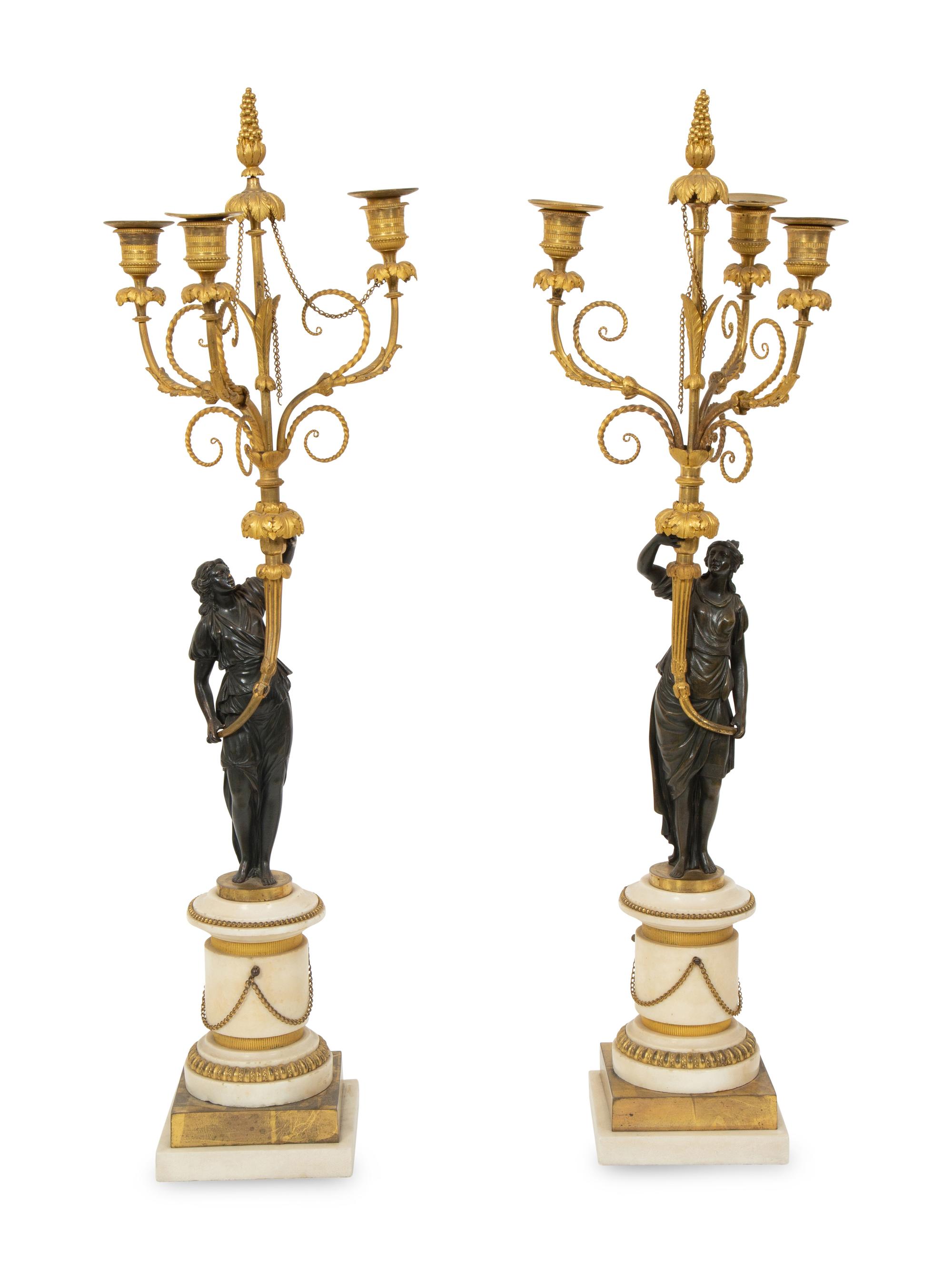 A Pair of French Patinated and Gilt Bronze Figural Three-Light Candelabra