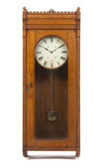 An American Oak Regulator Clock, Height 57 1/4 inches.
