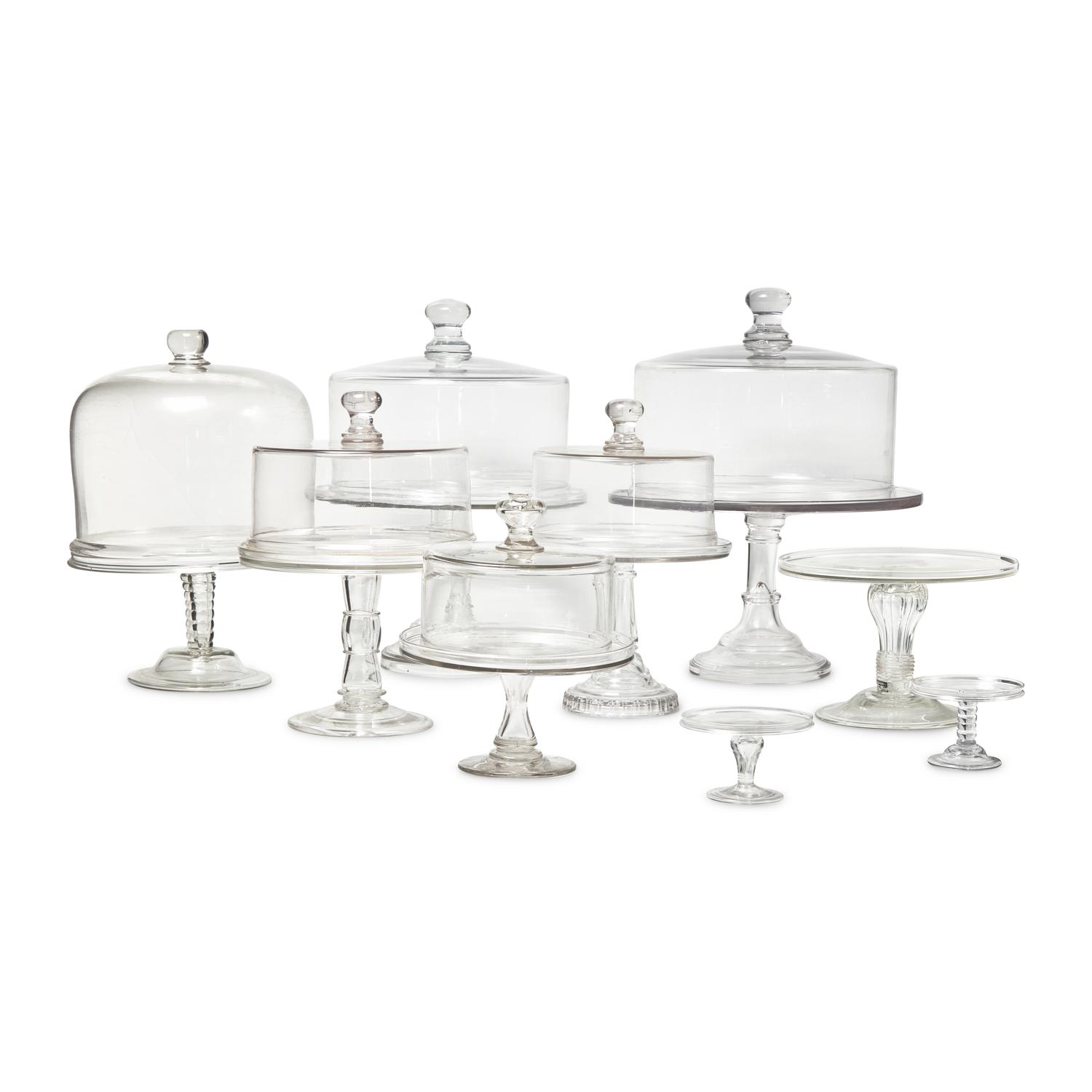 A Group of Nine Blown and Cast Glass Footed Cake Plates and Covers