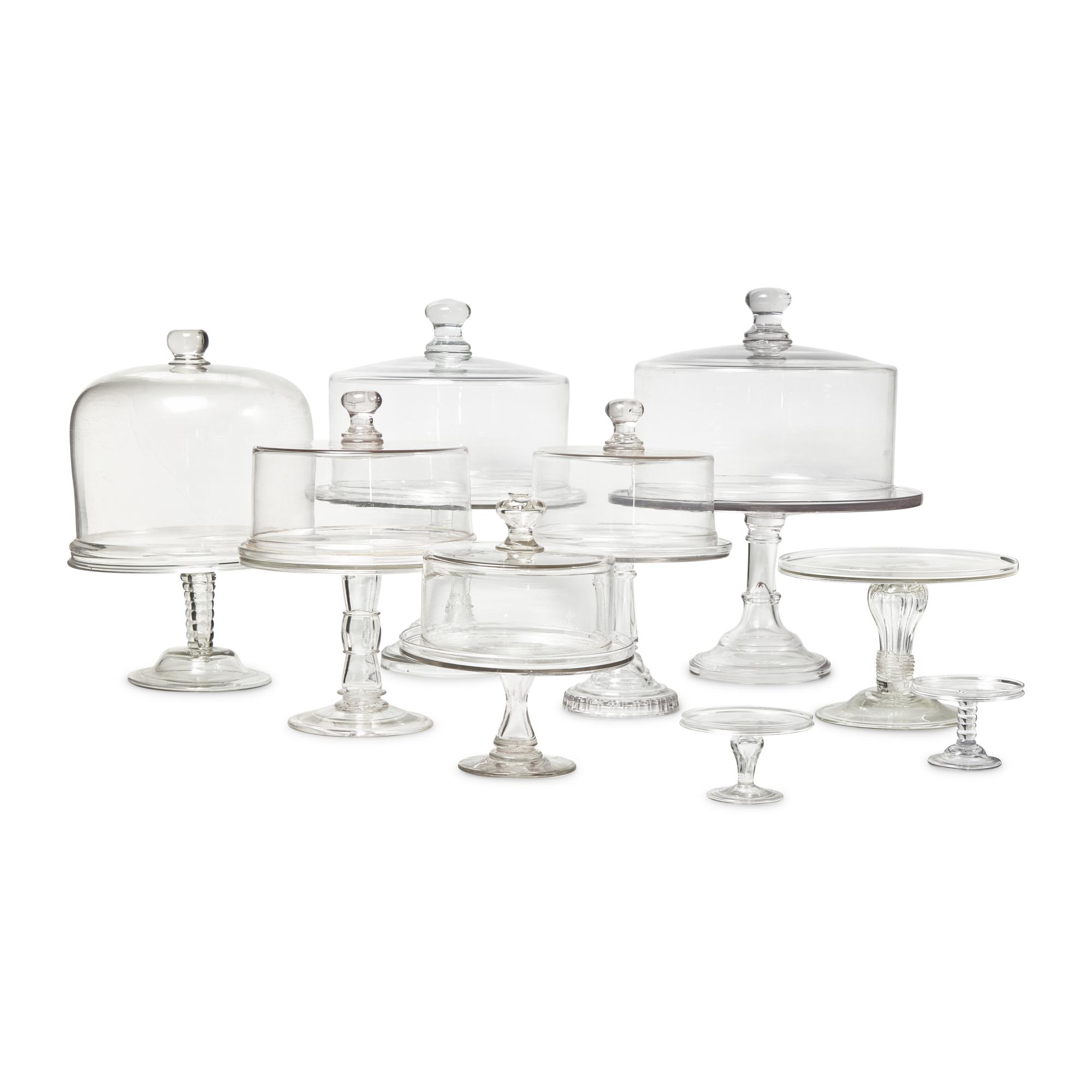 A Group of Nine Blown and Cast Glass Footed Cake Plates and Covers