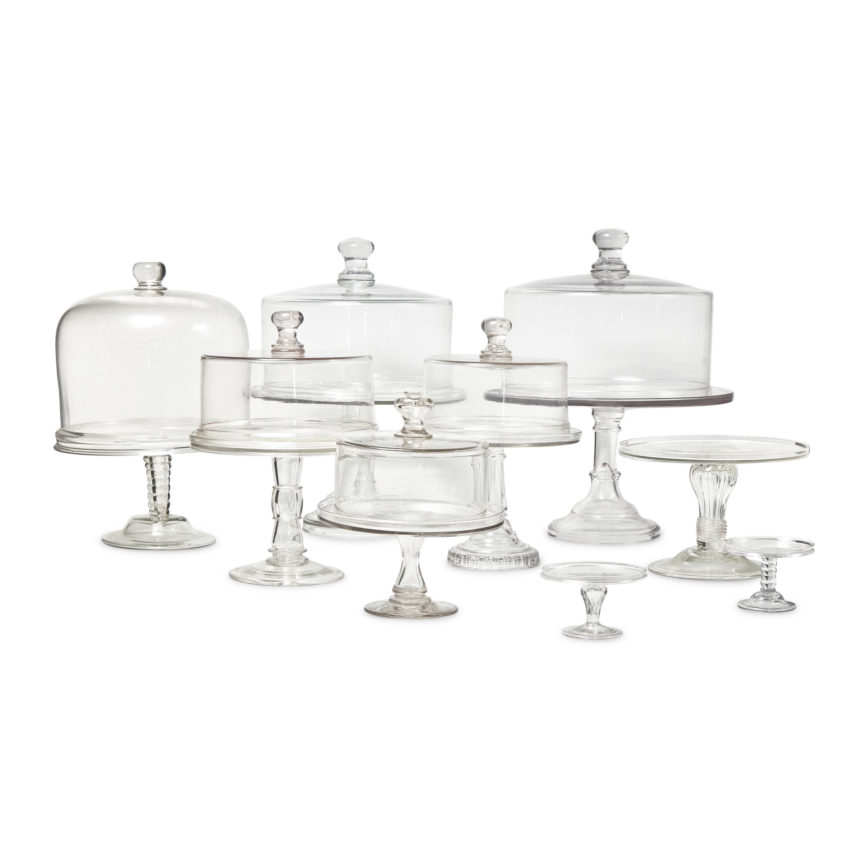 A Group of Nine Blown and Cast Glass Footed Cake Plates and Covers