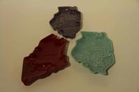 A Collection of Thirteen Haeger Pottery Ash Receivers Width of widest 18 1/2 inches.