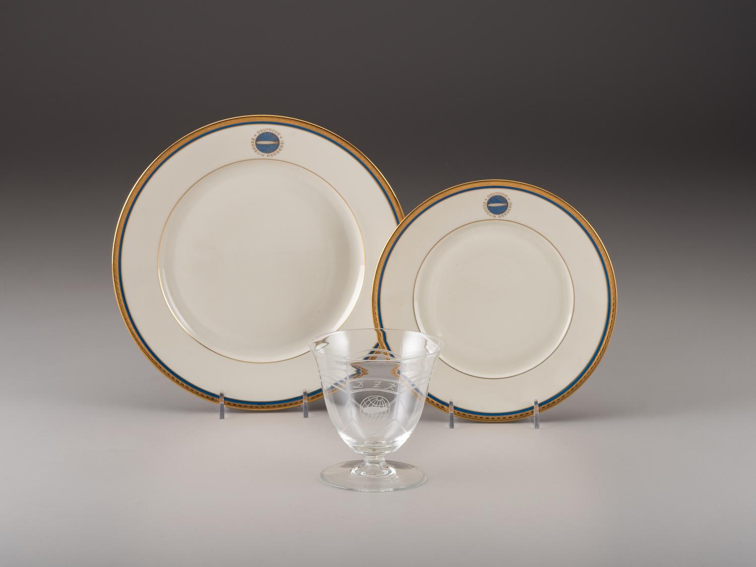 [TRANSPORTATION] - [ZEPPELIN]. Set of Deutsche Zeppelin-Reederei porcelain with dinner plates, salad plates, and sherbet glasses.