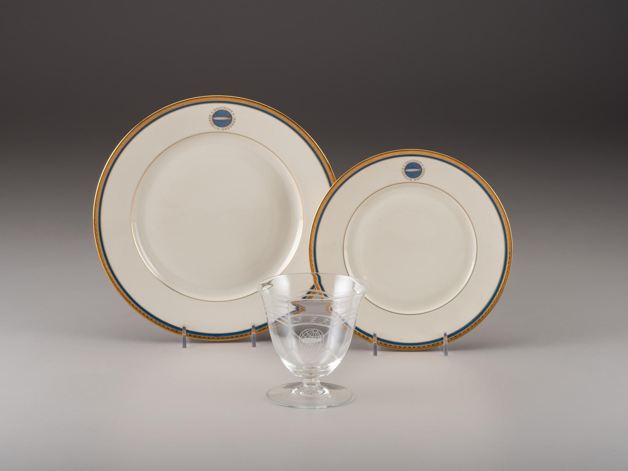 [TRANSPORTATION] - [ZEPPELIN]. Set of Deutsche Zeppelin-Reederei porcelain with dinner plates, salad plates, and sherbet glasses.