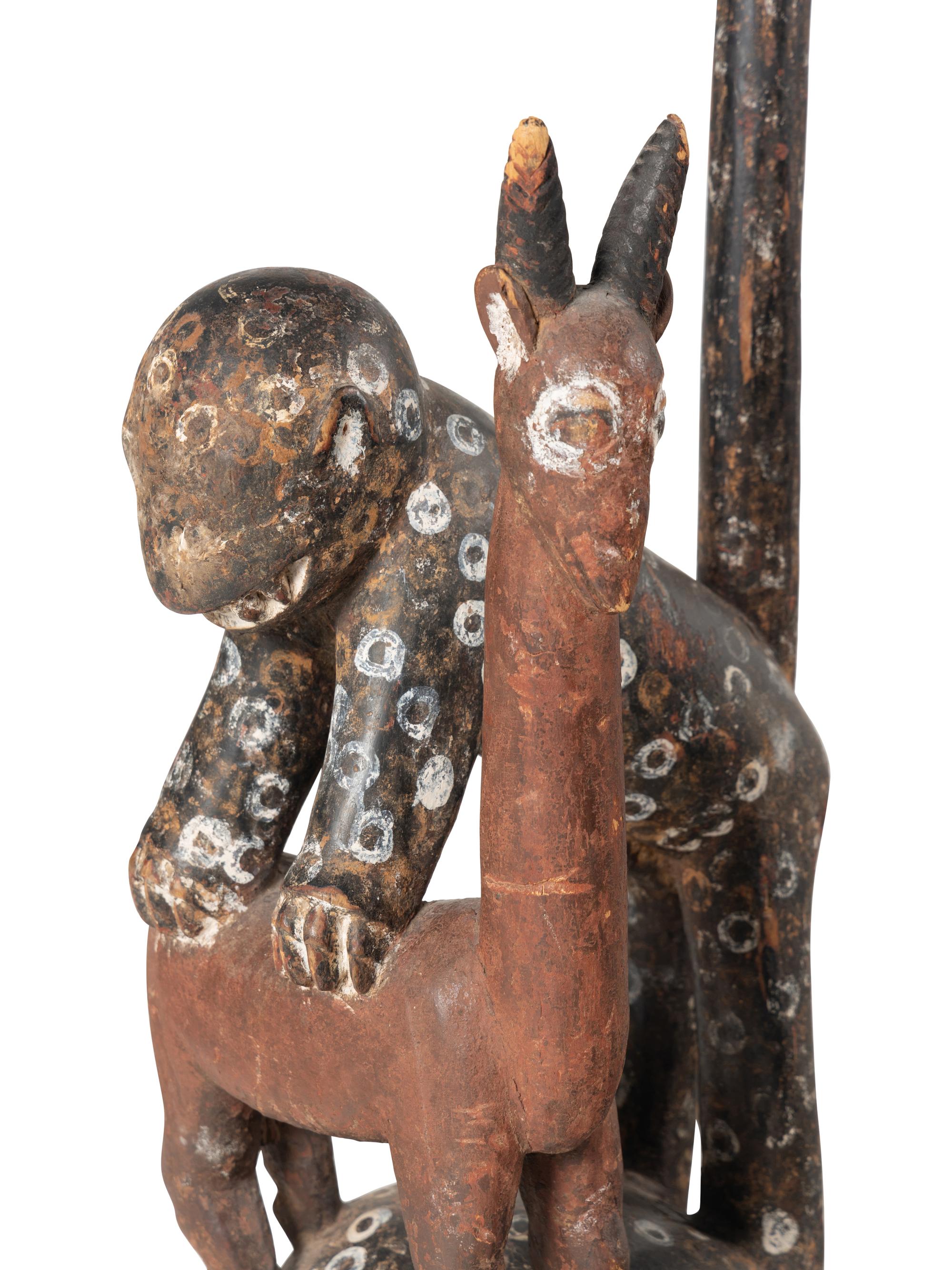 An African Carved and Painted Wood Monkey and Gazelle Figural Group