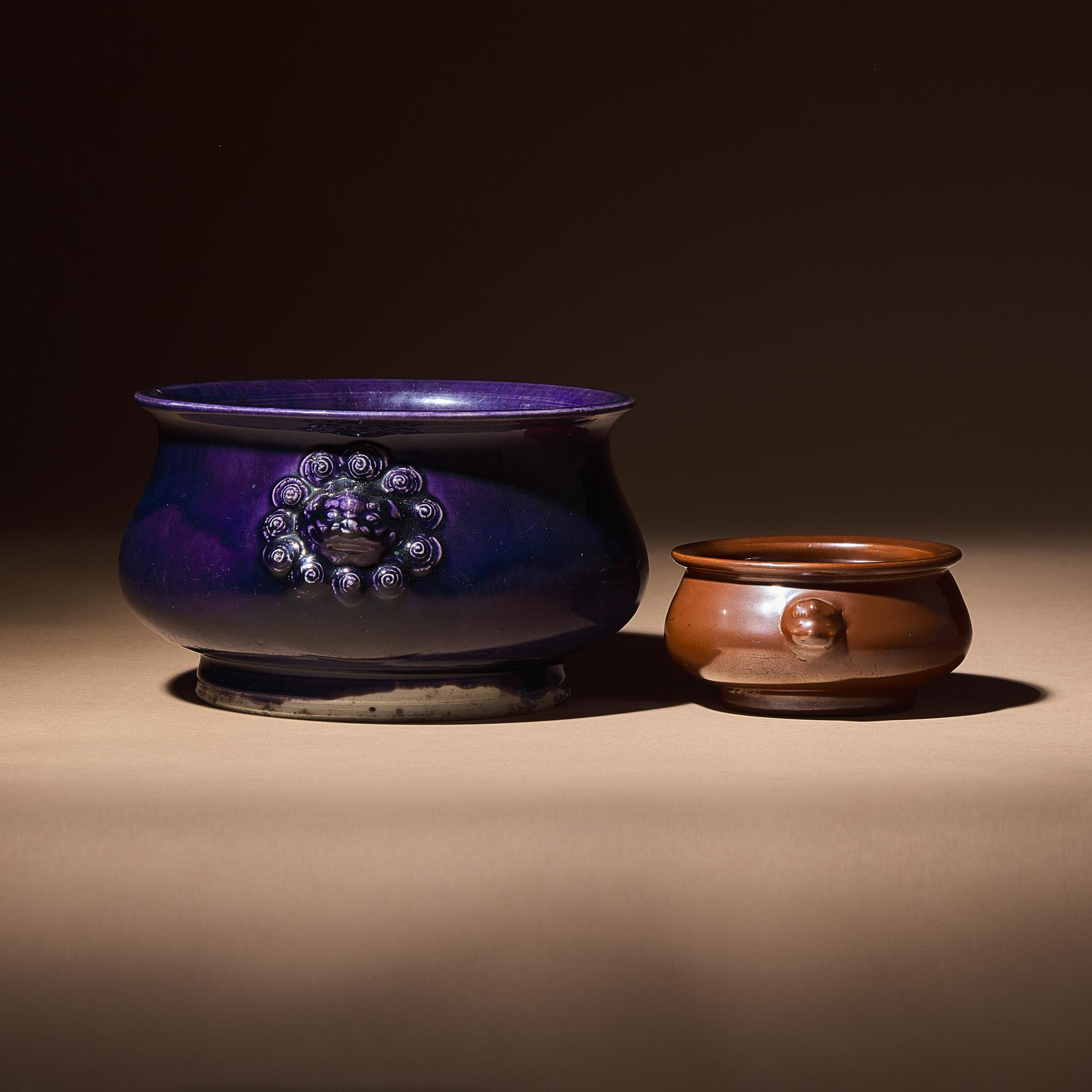 Two Chinese Monochrome Glazed Porcelain Censers, 17th-18th Century — 清早中期 紫金釉及藍釉獅耳爐兩具
