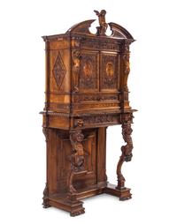 A Renaissance Revival Carved Walnut Cabinet on Stand