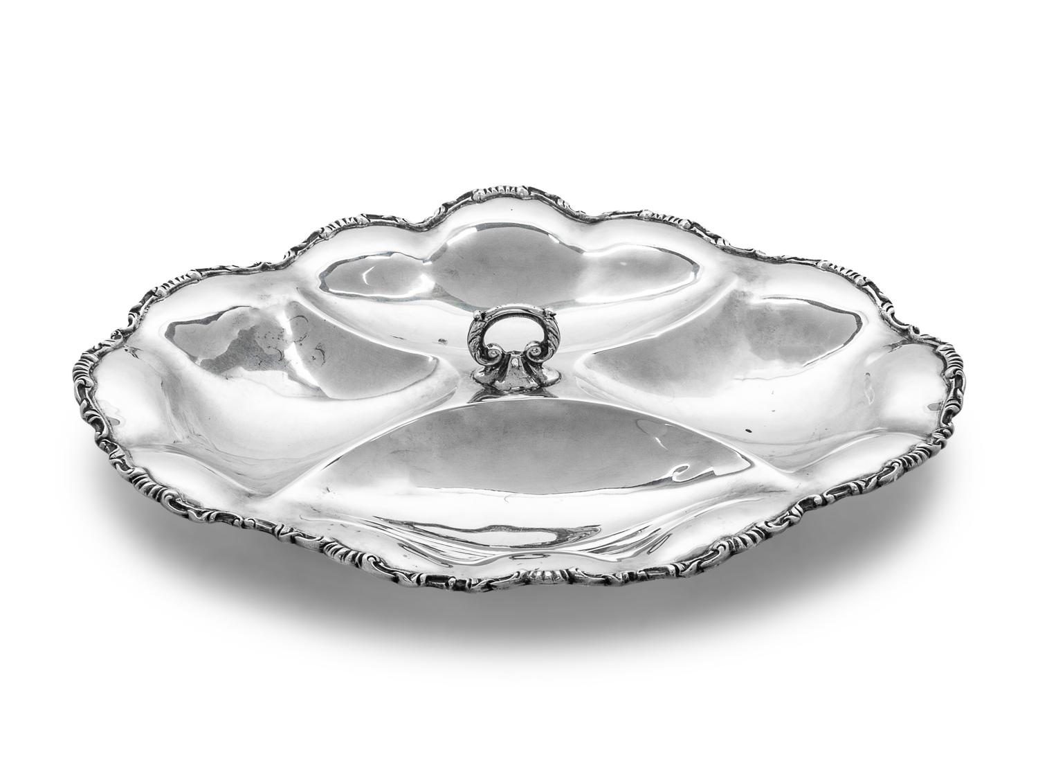 with center handle and foliate scalloped edge.