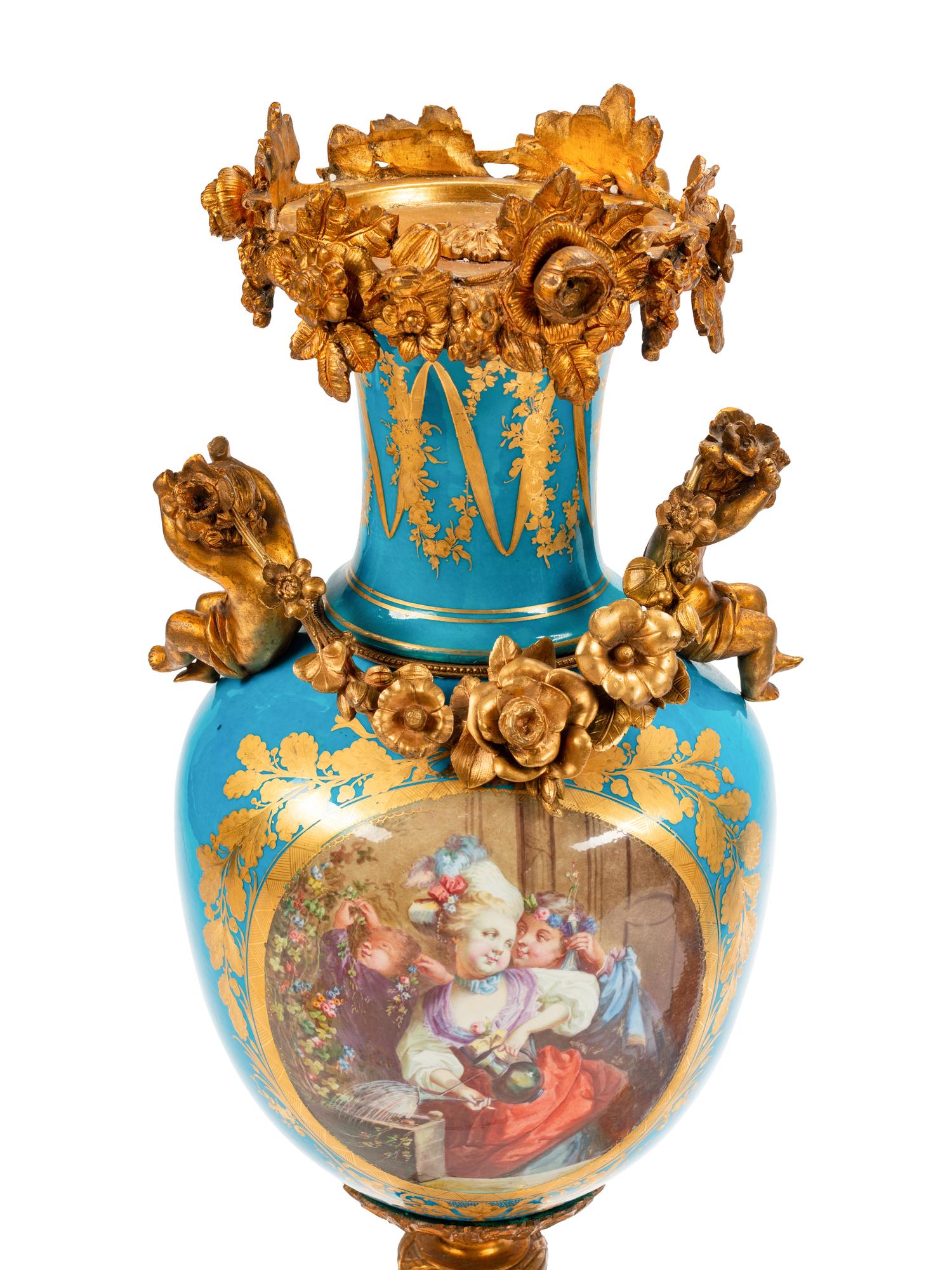 A Pair of Sèvres Style Gilt Bronze Mounted Porcelain Urns