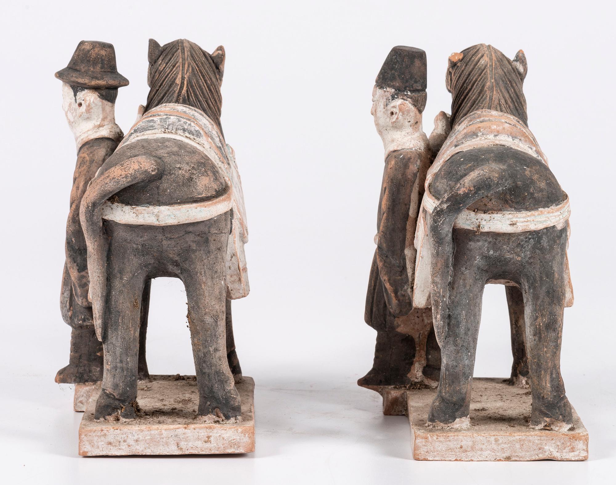 A Pair of Chinese Terracotta Horses with Standing Attendants