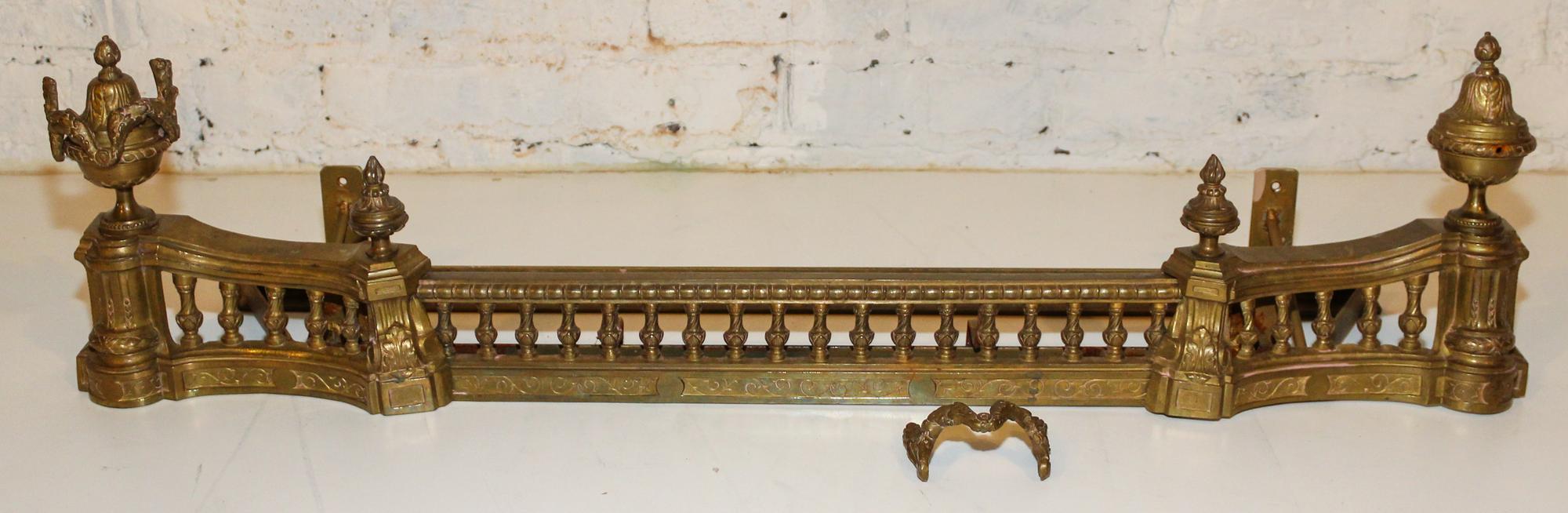 A French Gilt Metal Fire Fender Height 10 3/8 x width 38 1/2 inches.