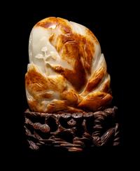 A Chinese Celadon and Russet Jade 'Landscape' Boulder