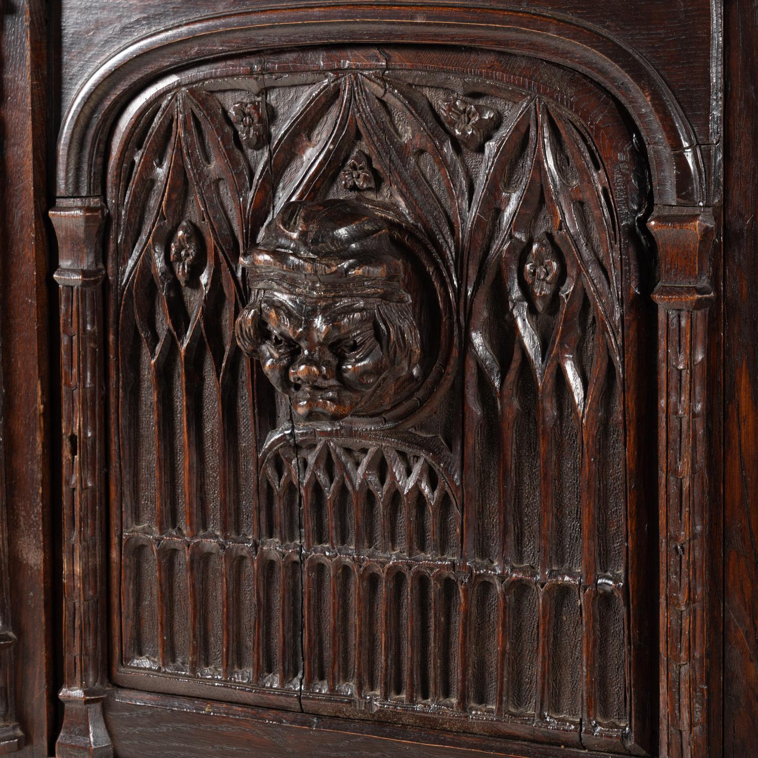 A Gothic Revival Carved Oak Court Cupboard