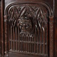 A Gothic Revival Carved Oak Court Cupboard