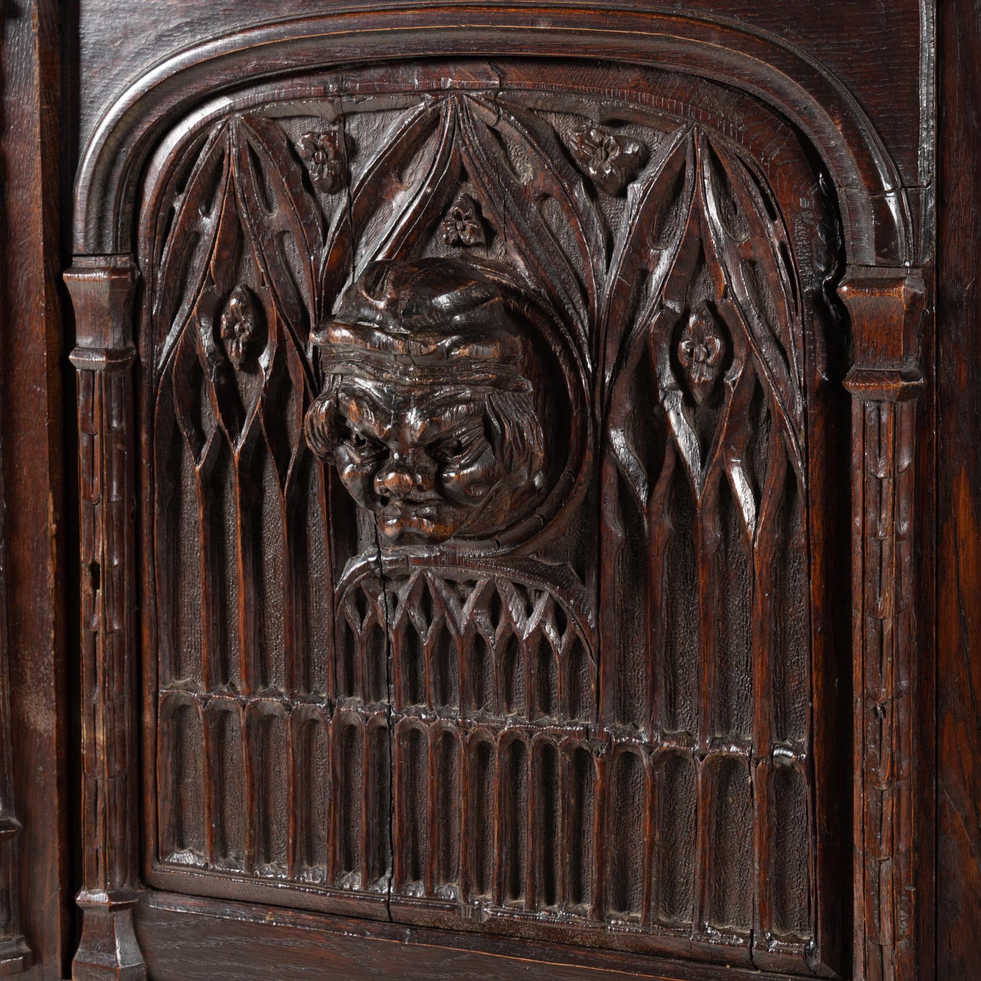 A Gothic Revival Carved Oak Court Cupboard