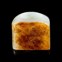 A Chinese White and Russet Jade Archer's Ring